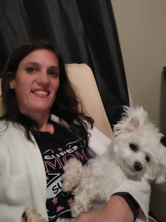 White Maltipoo Laying with Momma.