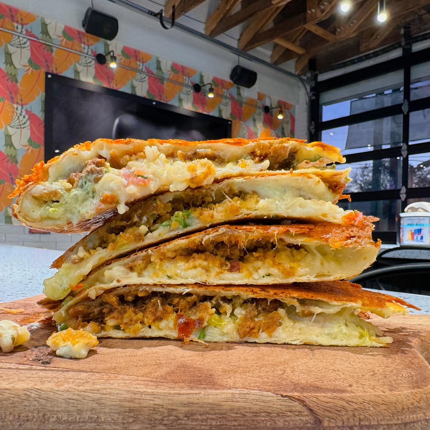 Brisket Tamales in a quesadilla ended up being a solid decision 👌 get the monthly drop while you can 🕷️

La Madrina 
Brisket tamales 
Rice
Notorious queso
Salsa verde
Sour cream
Pico
Cilantro