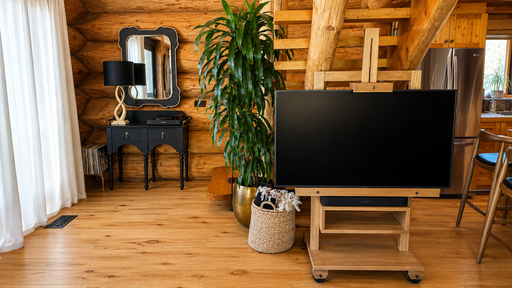 Living room with a rolling television and the kitchen beyond