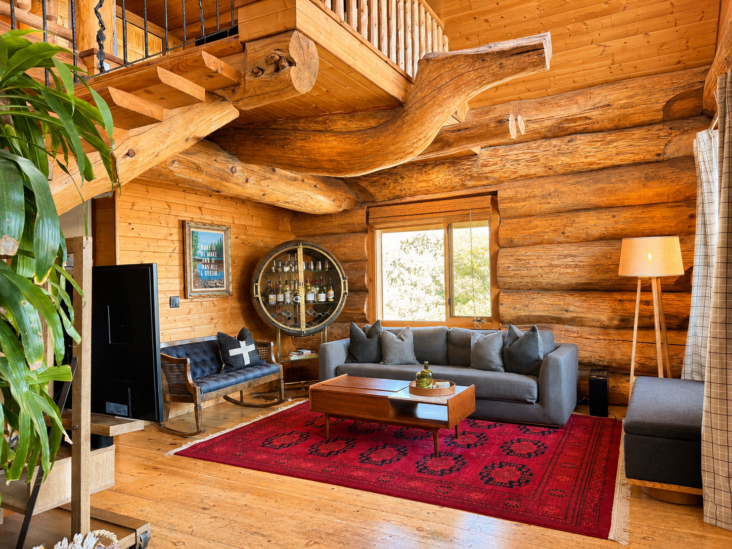 Cabin living room with a stocked bar cabinet, record player and log walls
