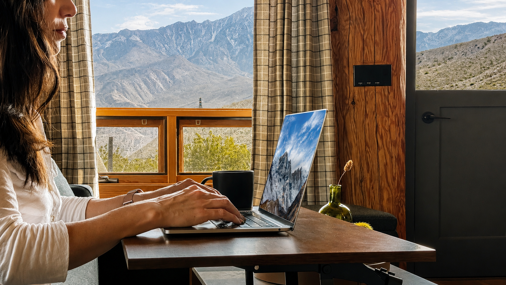 Working on a laptop with Starlink wifi and mountain views from the cabin