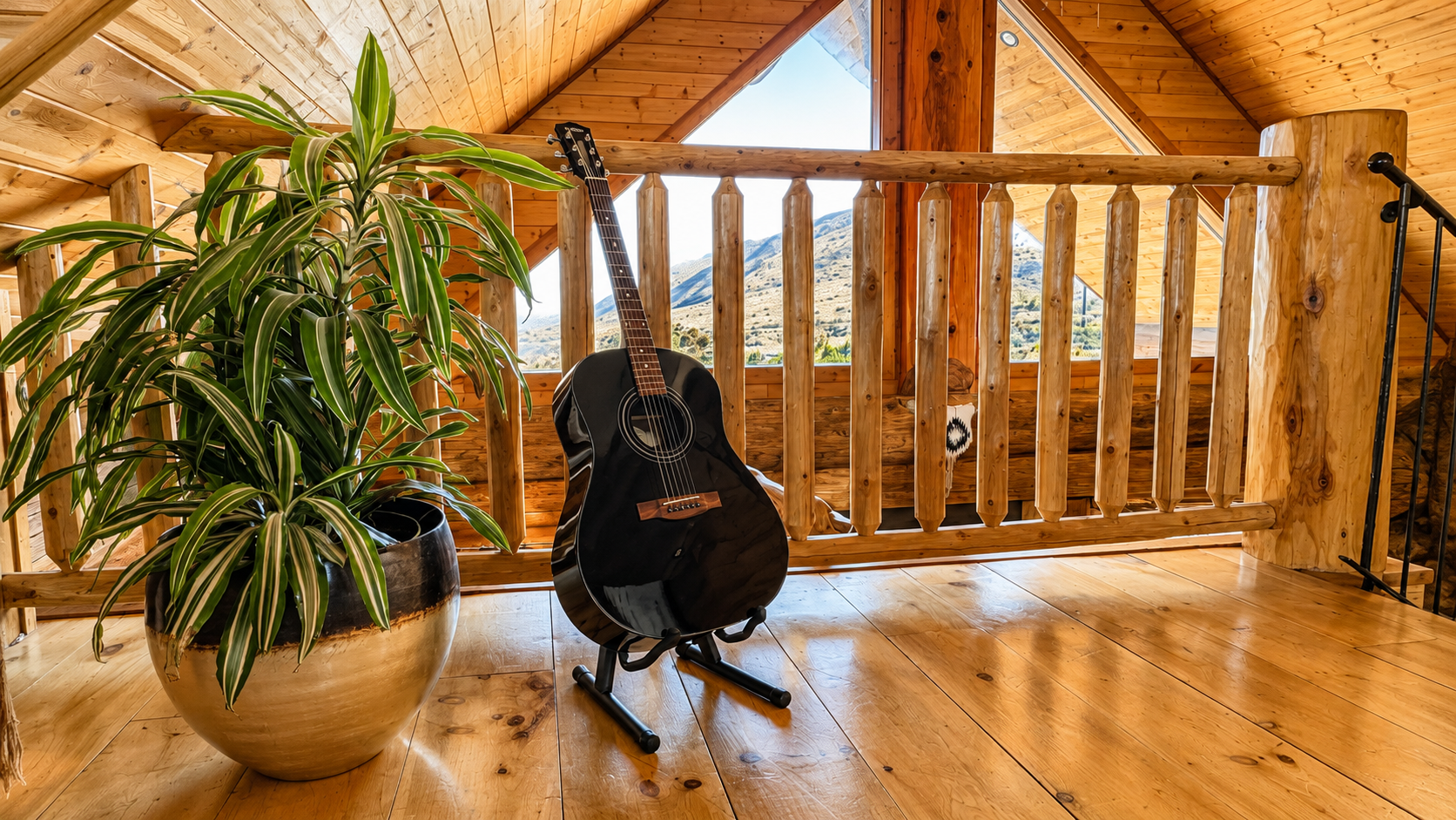 Guitar in the cabin loft beside the railing and gable window