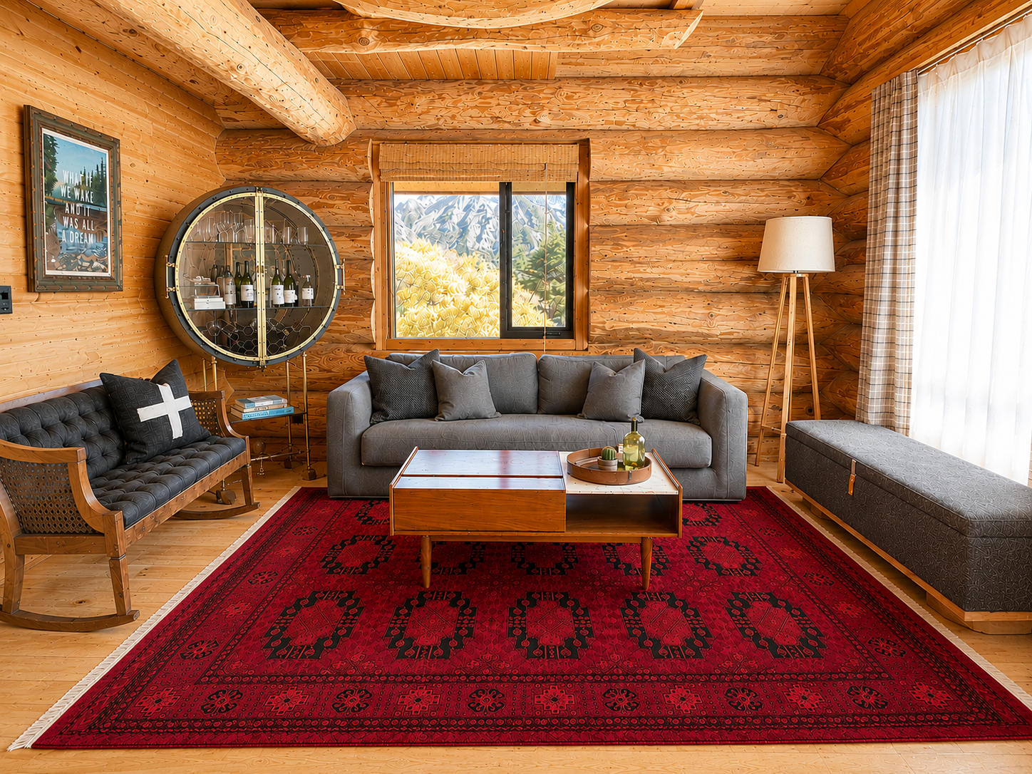 Cabin living room with sofa, wine cabinet and a mountain peak framed in the
window