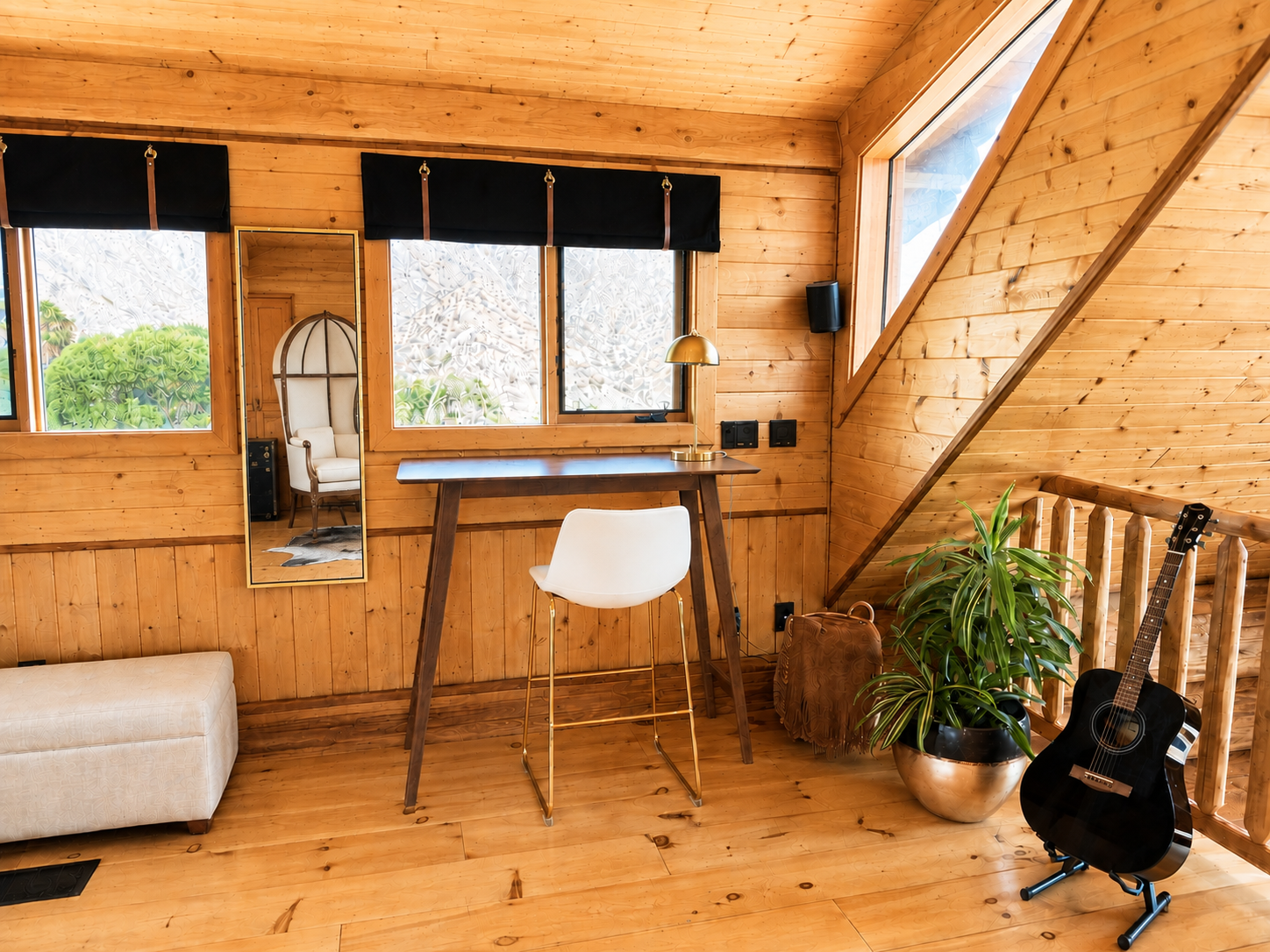 Desk and workspace in the cabin loft with windows on two walls