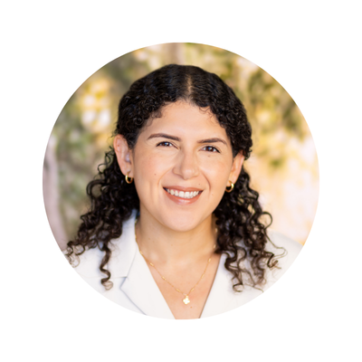 Happy smiling woman with trees in the background who does OCD treatment in San Diego, CA
