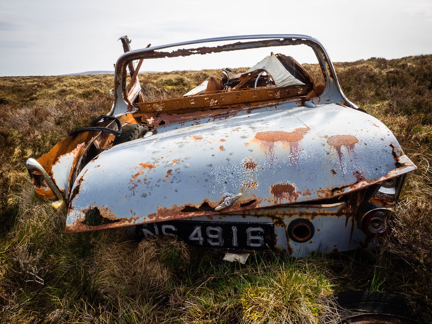 An abandoned car on the moor near the site of the new wind farm.