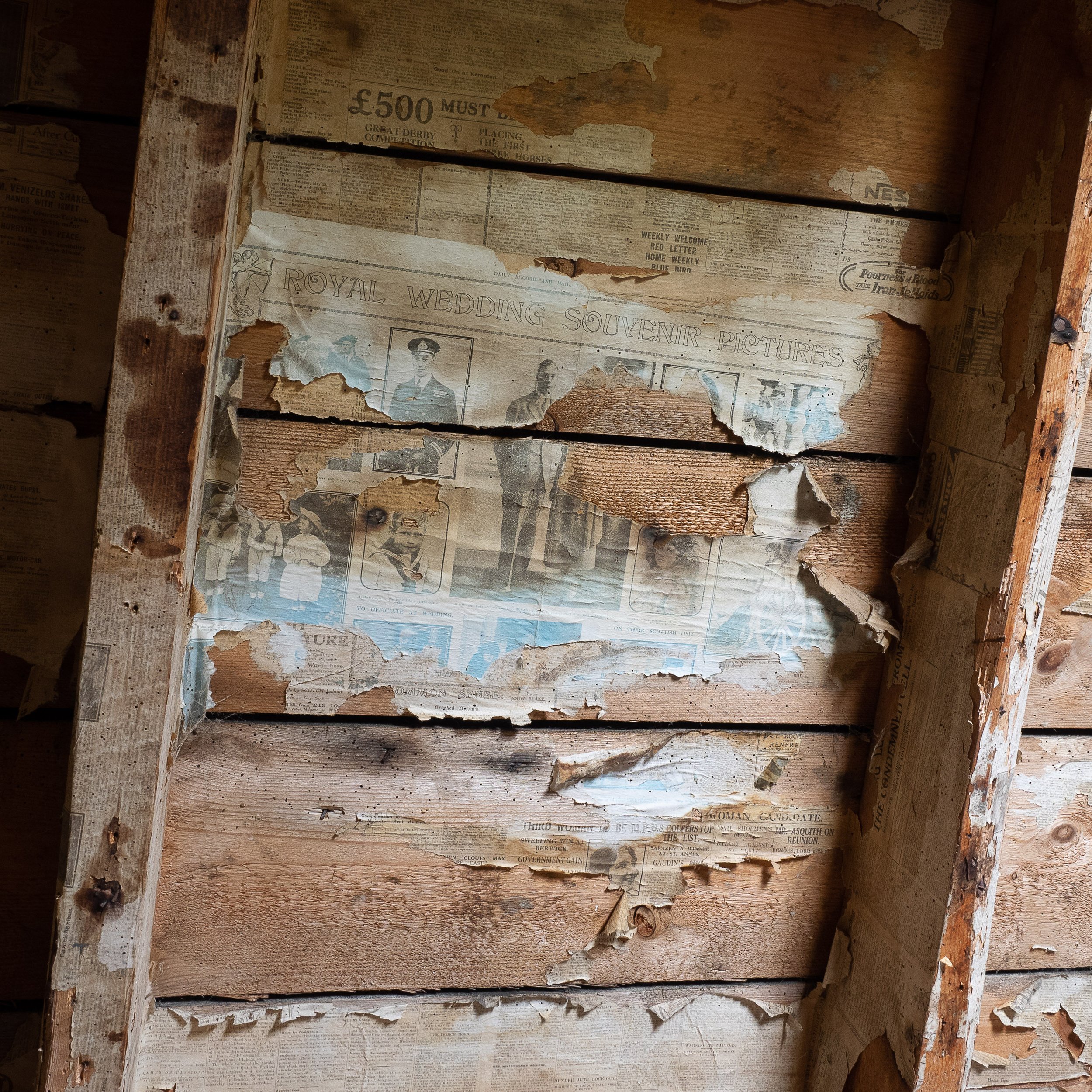 Newspapers pasted onto the roof space in one of the abandoned farm houses on the moor. The article celebrates the marriage of the Duke of York in 1923.