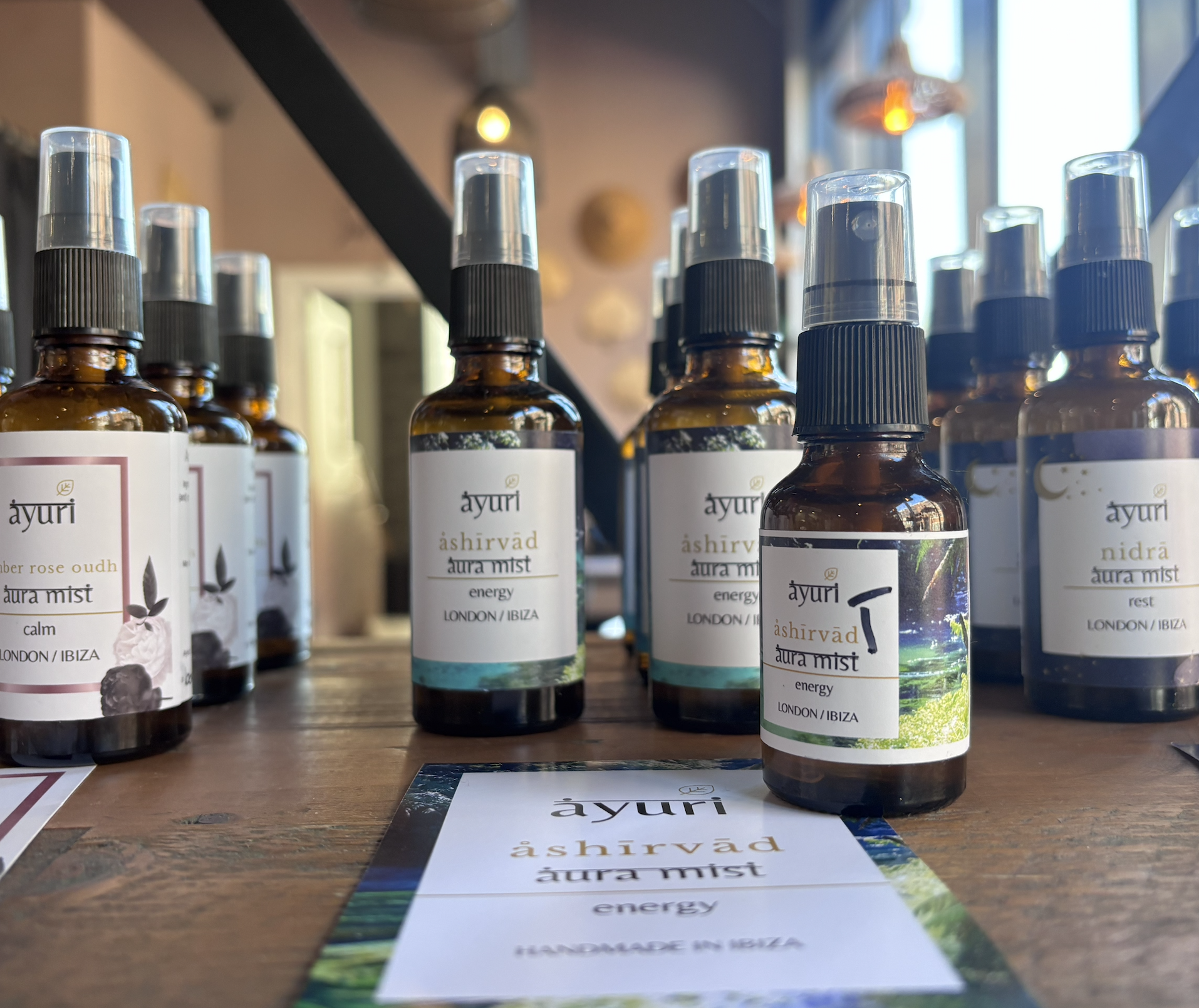 A line of brown class bottles containing a selection of ayurvedically blended aroma mists for energy, calm and sleep support.