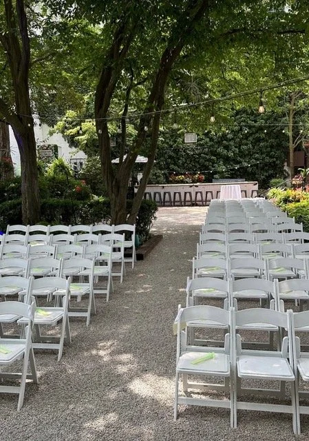  Outdoor Courtyard  
Lush green shrubs and twinkle lighted trees create a romantic ambiance for your quaint outdoor reception. Black and white, wrought iron patio sets accommodate your guests with umbrellas and tree coverage to protect from the eleme