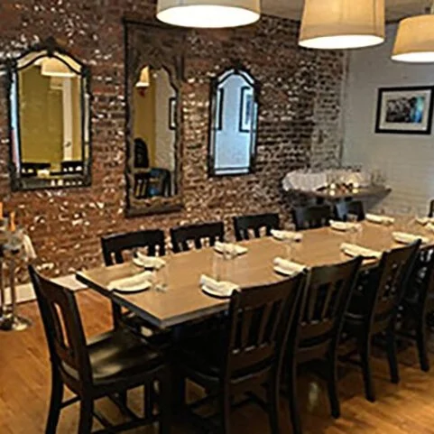  VIP Room  This space features a brick accent wall that adds a rustic touch and provides a beautiful backdrop for photos. Opposite the brick wall is a wall of windows that lets in plenty of natural light. The room can accommodate up to 20 seated gues