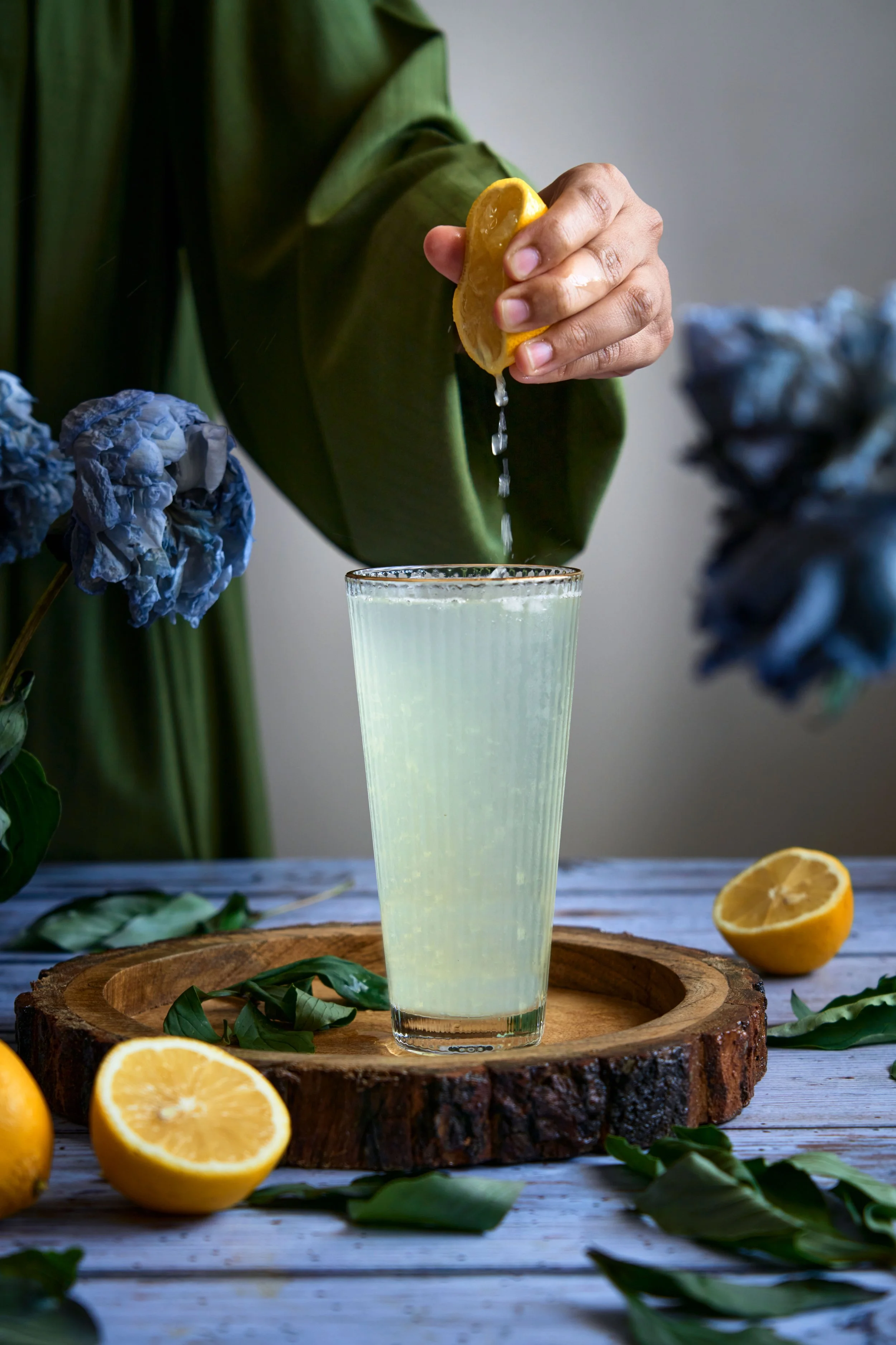 glass of lemonade, lemon juice drops falling into glass