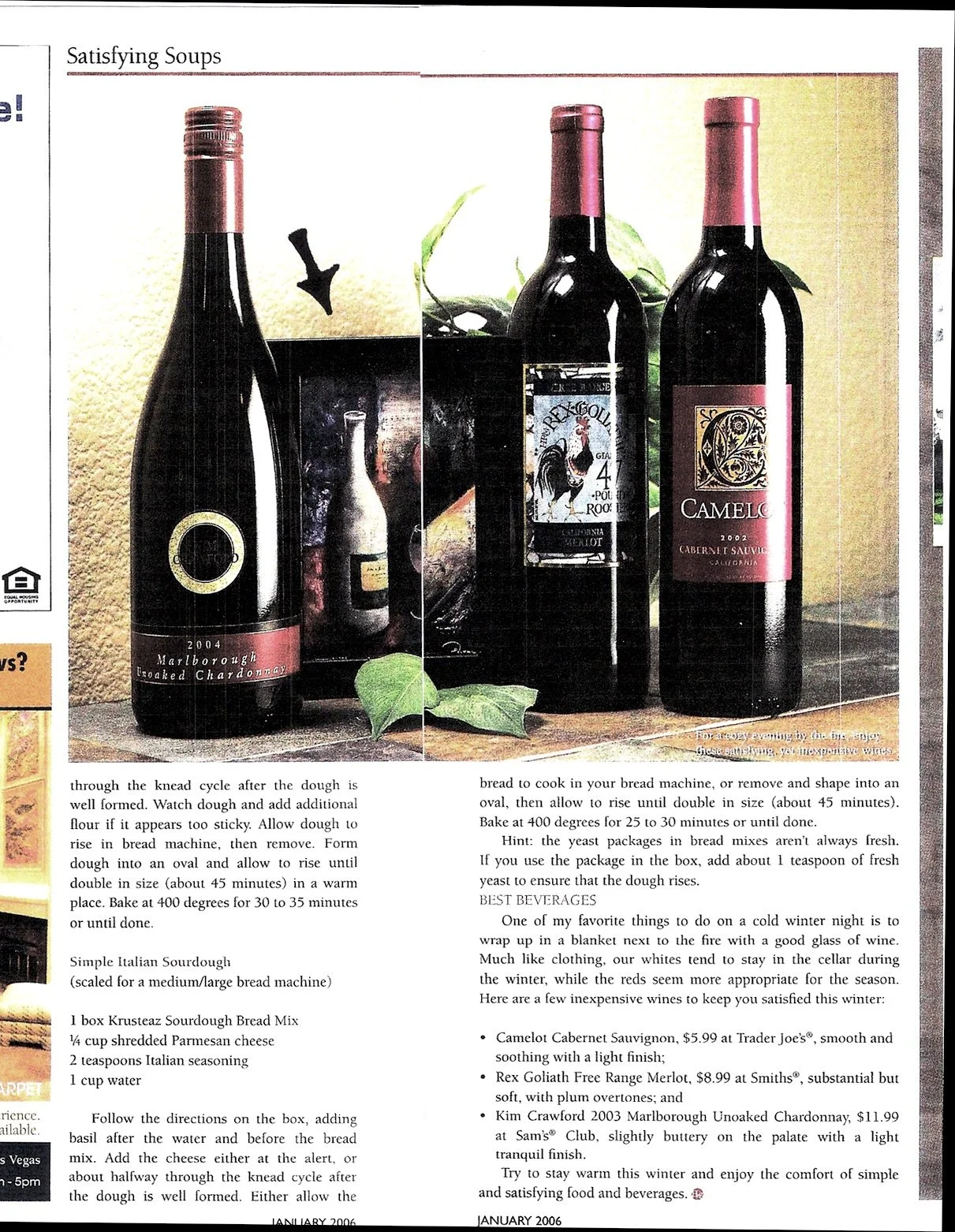 Three bottles of red wine with labels facing forward, positioned on a wooden surface with green leaves in the background.