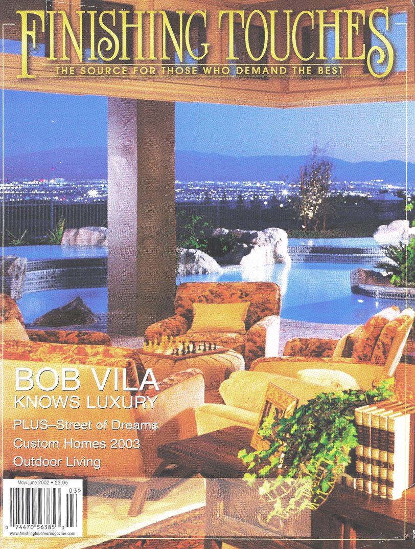 Magazines cover featuring a luxurious outdoor patio with tiled seating, a chessboard, and a view of a cityscape and mountains at dusk.