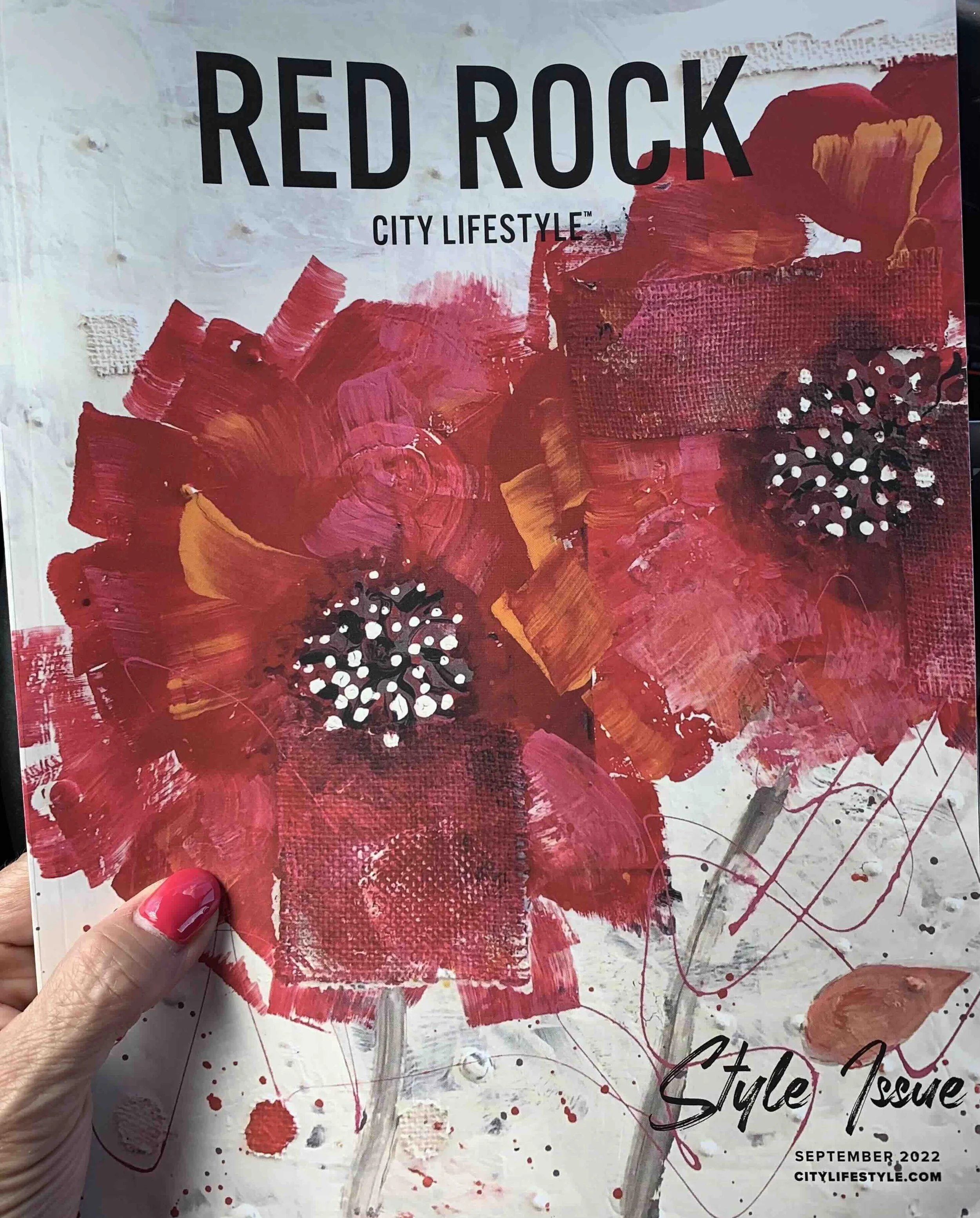 Cover page of a magazine titled "Red Rock City Lifestyle" with an abstract red, orange, and white painted background featuring splashes and textured brushstrokes. The bottom right corner displays the date "September 2022" and the website "citylifesty