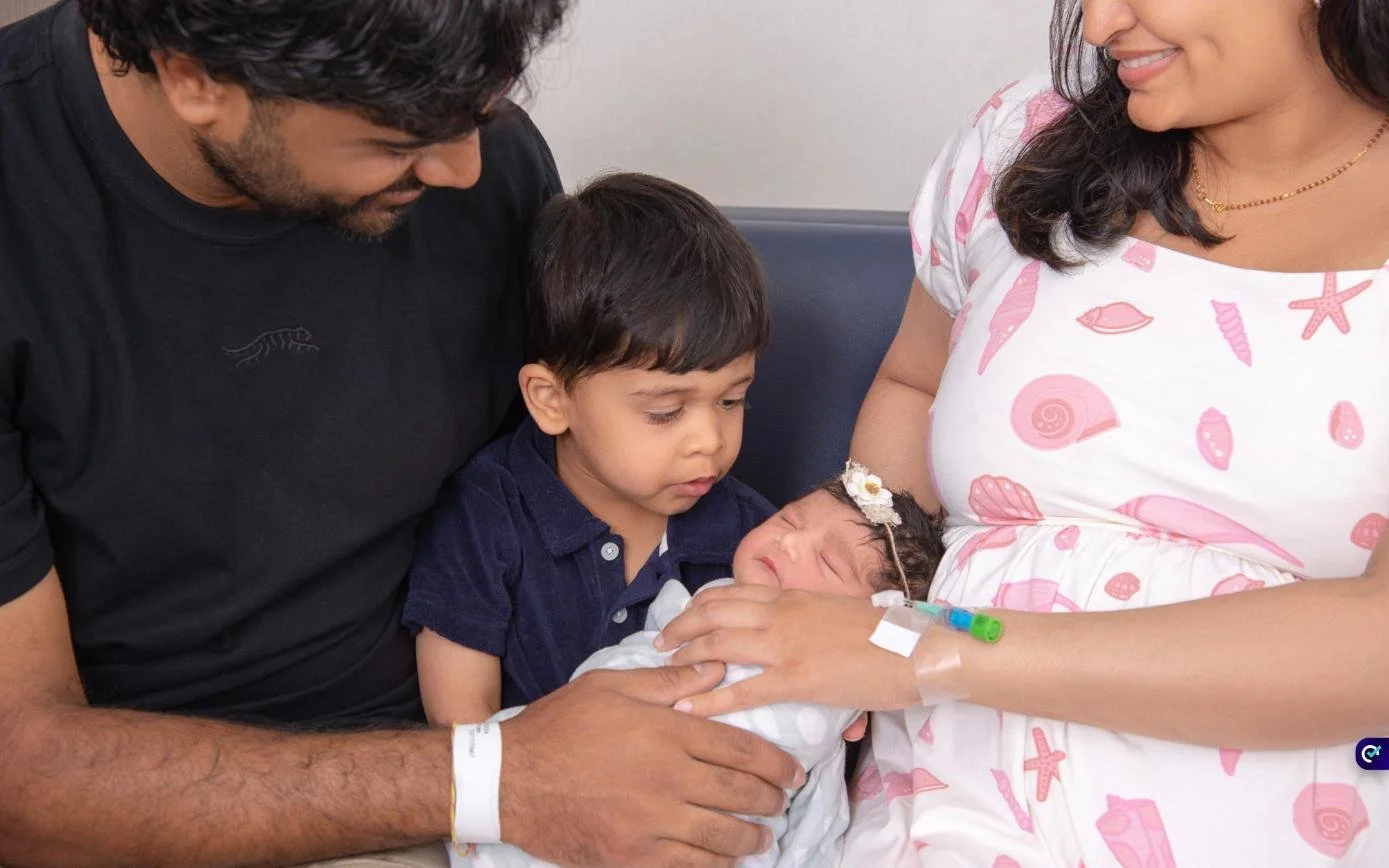 Dad and big brother admiring their newborn during a Fresh48 hospital photo session at Clara Maass Medical Center, Belleville NJ
