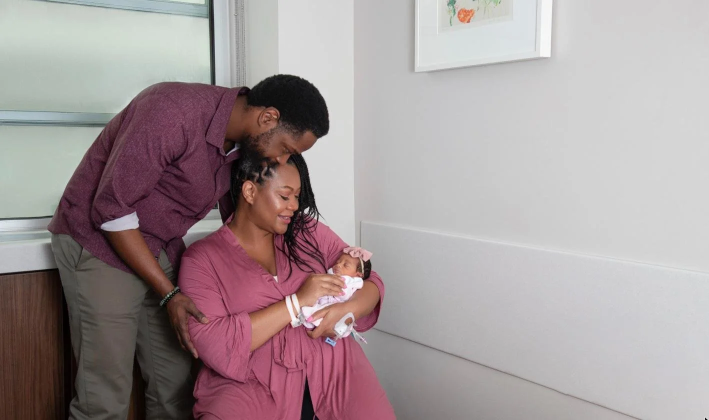 Parents with their newborn daughter during a Fresh48 hospital photo session at Robert Wood Johnson University Hospital, New Brunswick NJ