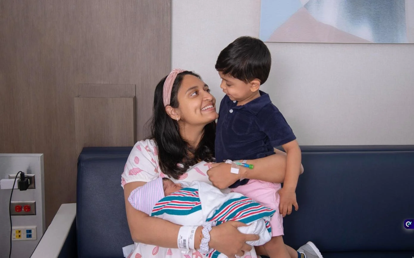 Mother with her newborn and toddler during a Fresh48 hospital photo session at Forest Hills Hospital, Queens NY