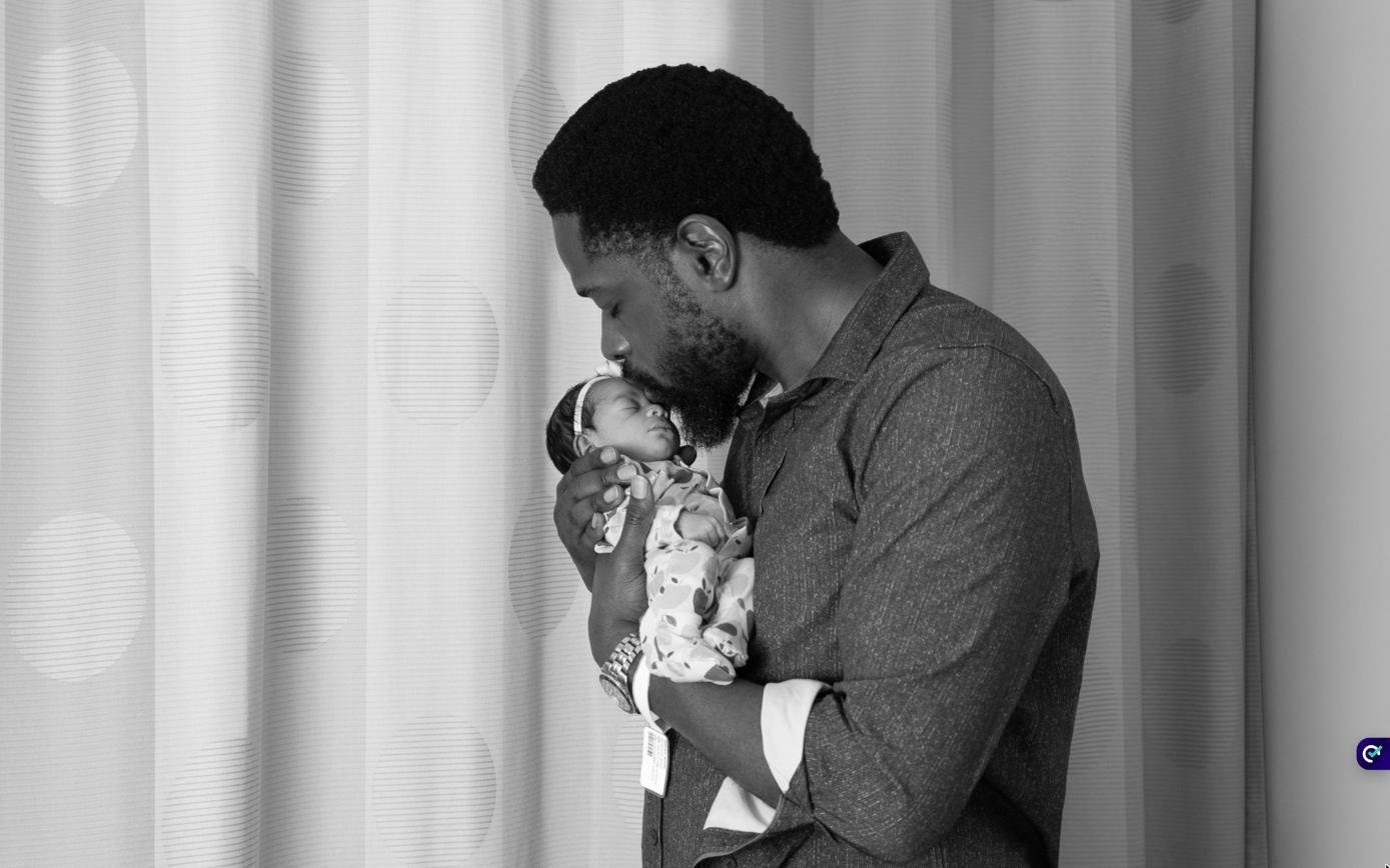 Father kissing his newborn daughter during a Fresh48 hospital photo session at Danbury Hospital, Connecticut