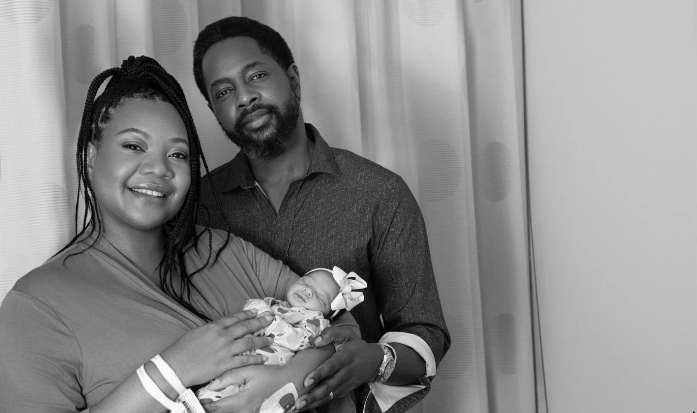 Parents holding their newborn daughter during a Fresh48 hospital photo session at Yale New Haven Hospital, Connecticut