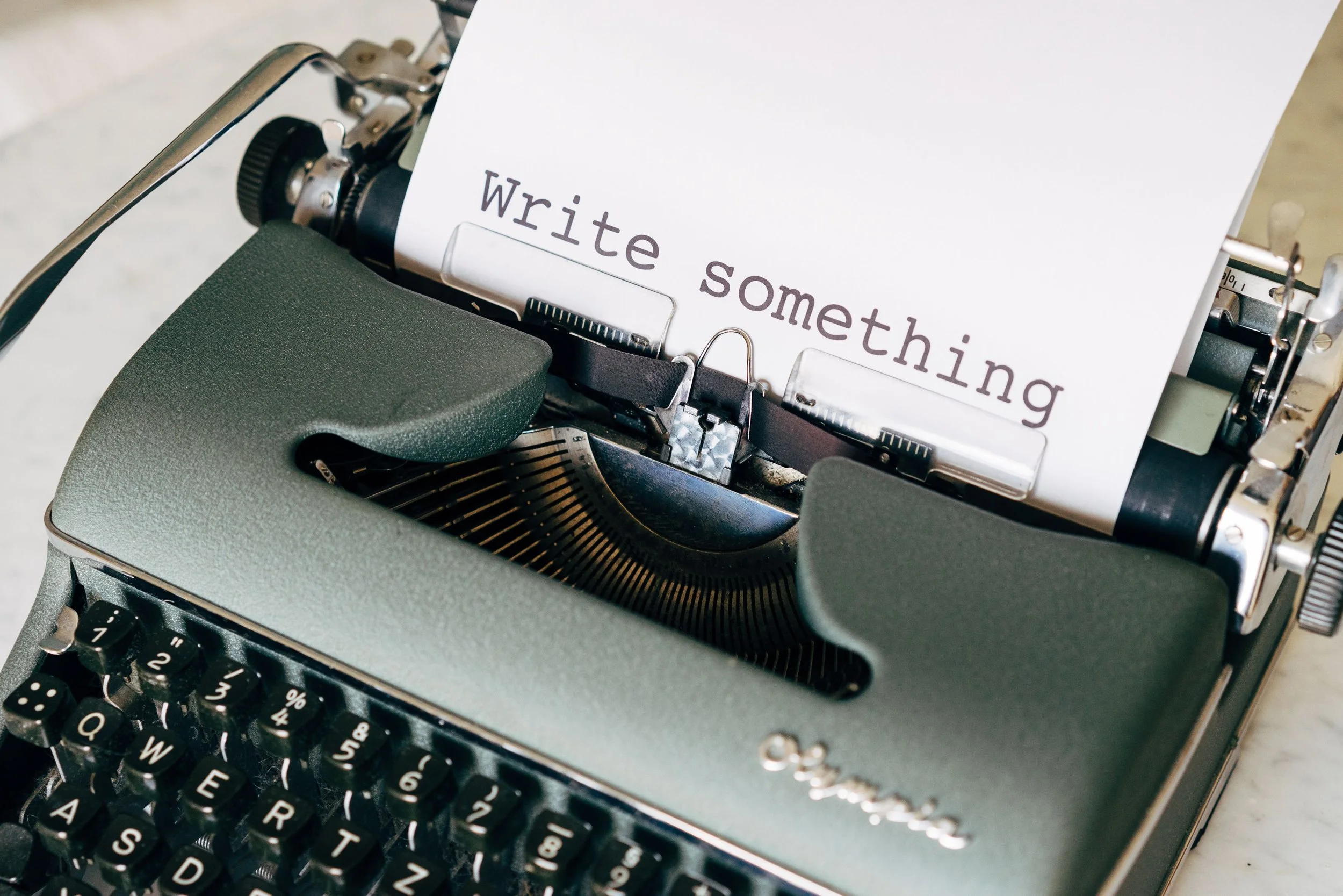 Manuual typewriter with the words WRITE SOMETHING.