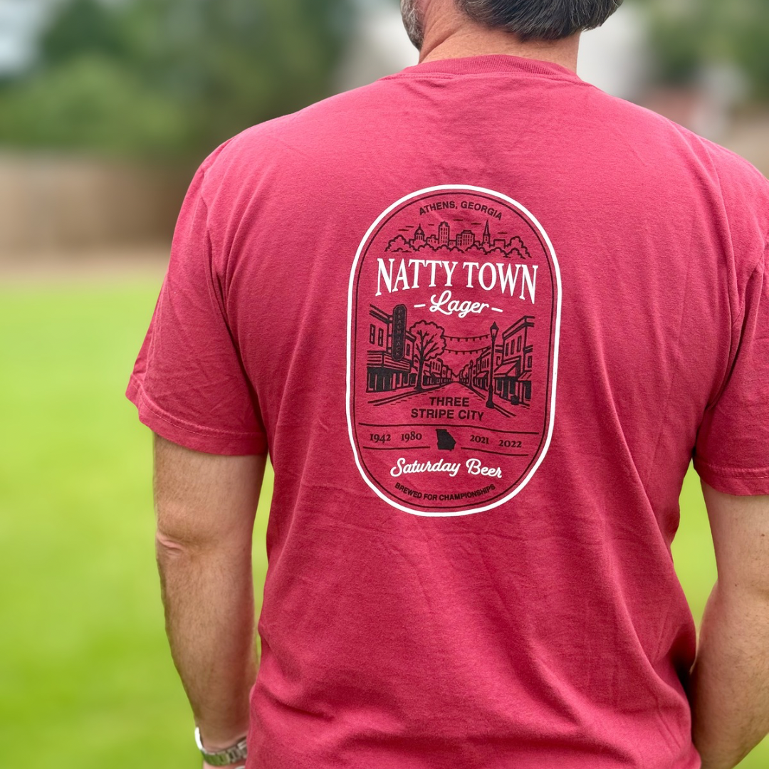 Man wearing Peach Jack Apparel Natty Town Lager Comfort Colors pocket tee showing the back side of the shirt inspired by college football Saturdays in Athens, Georgia.