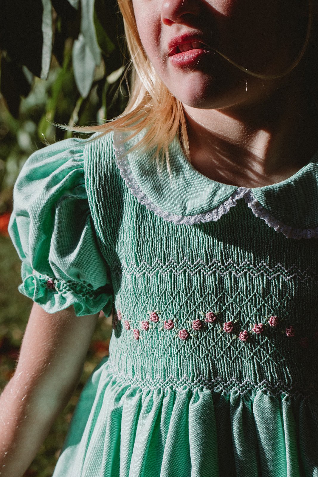 A full bodice of smocking and embroidered grub roses on the Elizabeth dress for baby, toddler and girl.