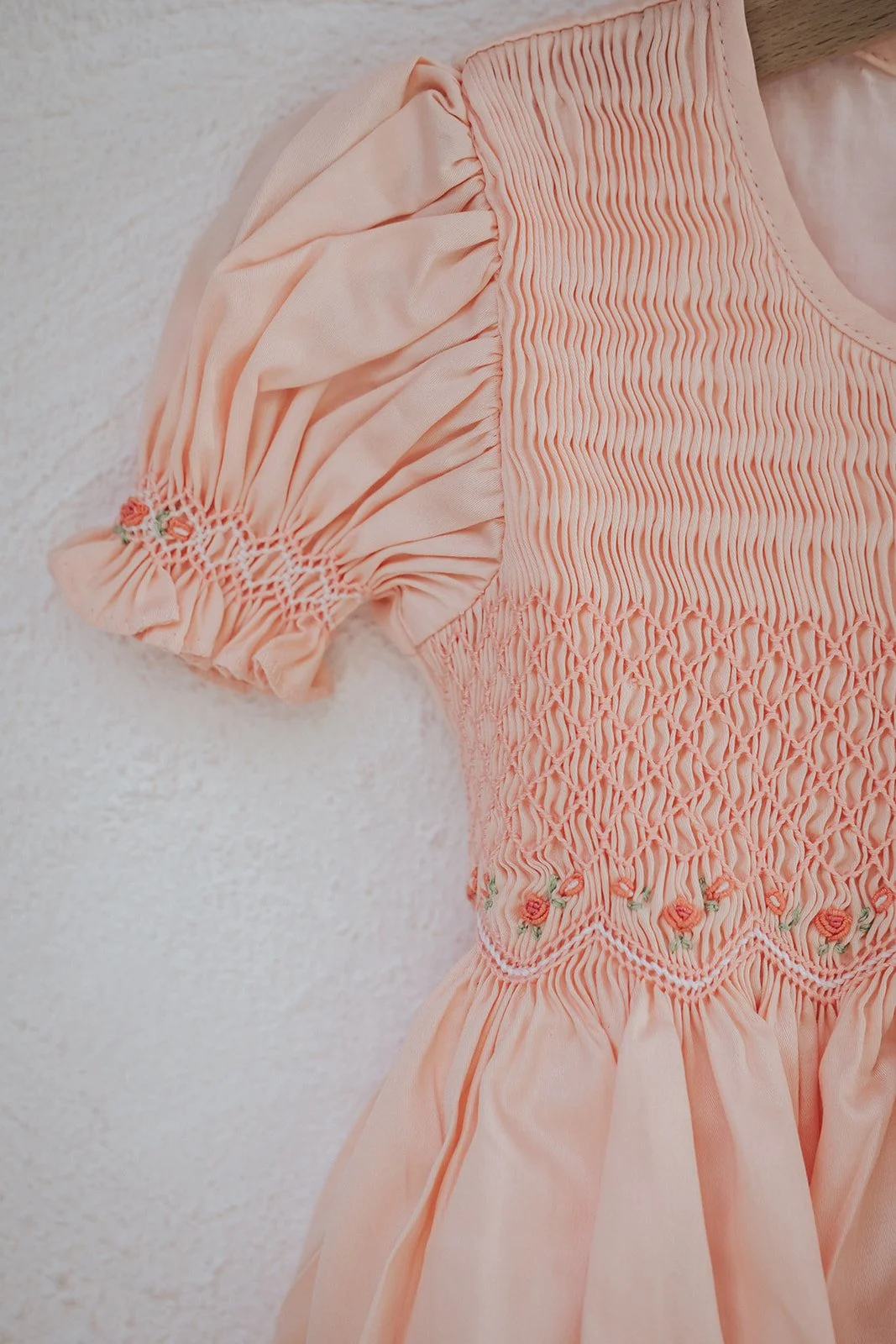 Detail of hand-smocked dress for baby toddler little girl, embroidery and puff sleeves.