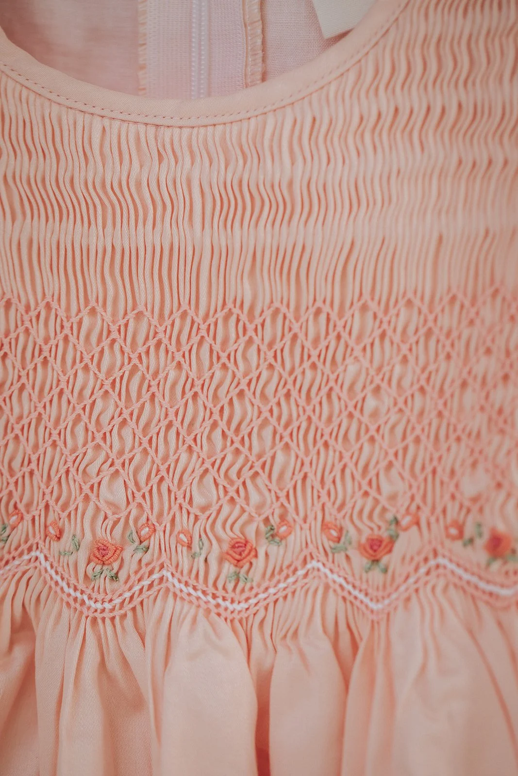 Detail of diamond smocking, grub roses embroidery, Australia handmade girls clothes in traditional vintage style 1950s.
