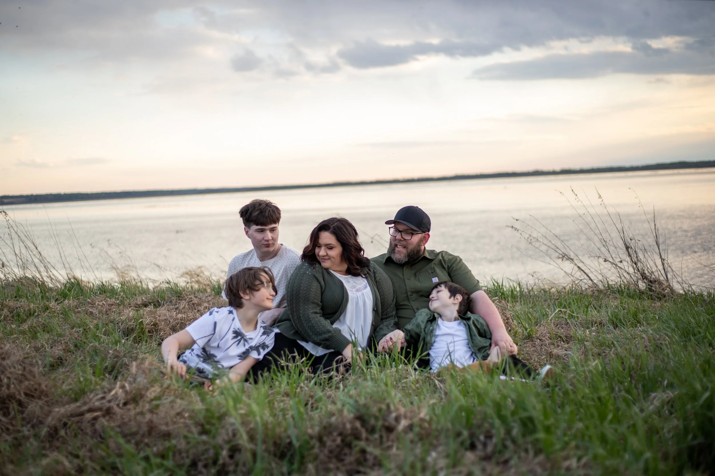 Family laughing together during lakefront photos in Edmonton