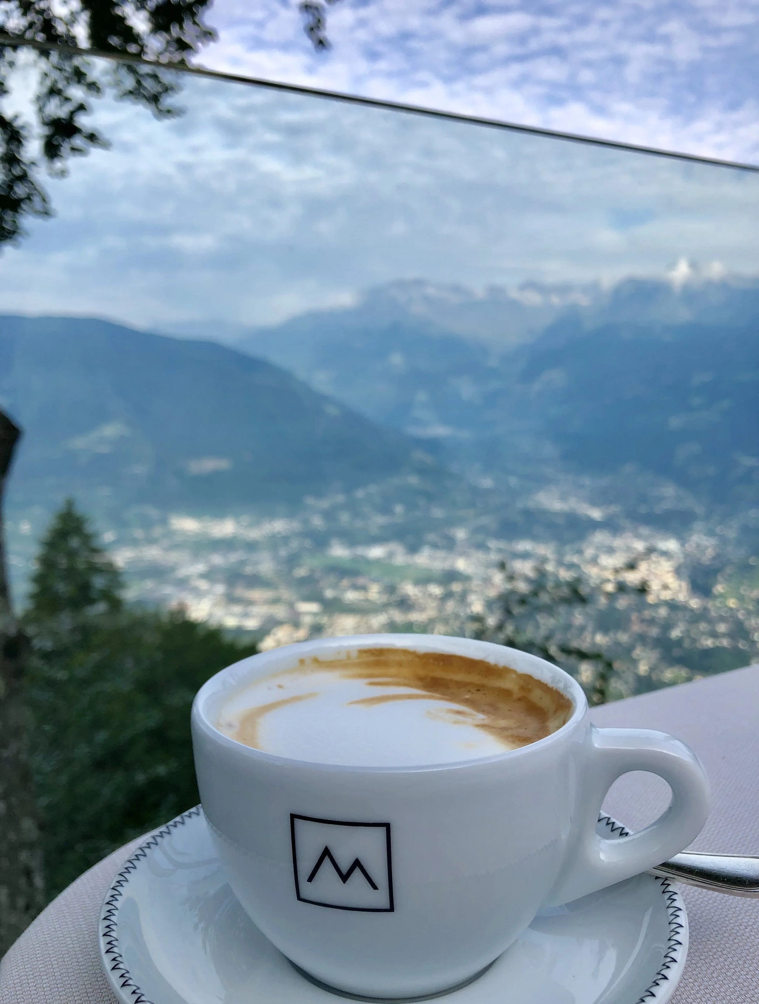 Three things that makes a coffee taste better: the company you drink it with, the cup and the view. Like here at Miramonti Hotel in Hafling, Italy high up on a mountain top over looking the city of Merano.
