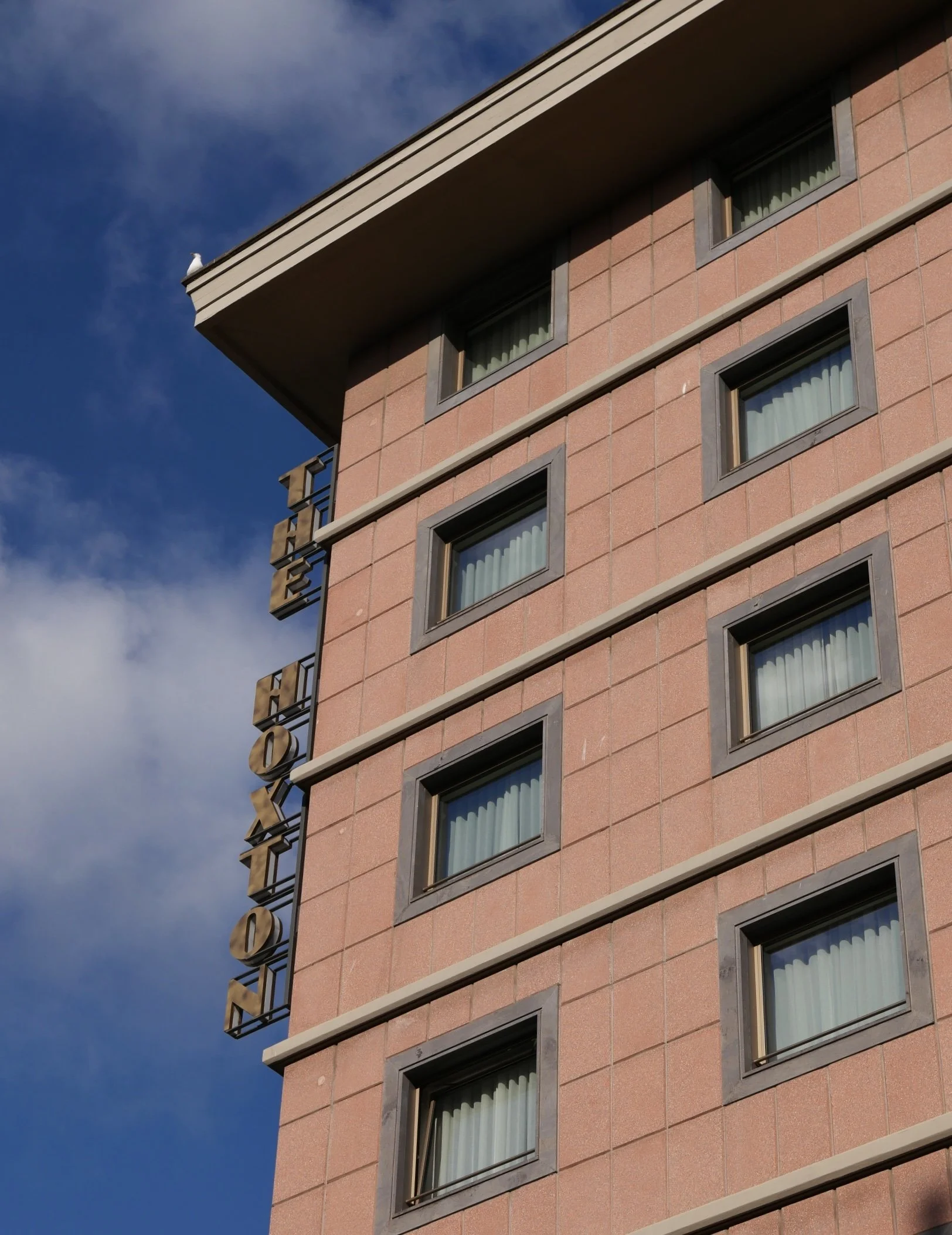 Rome hotel in a dusty pink 70s building with an interior oozing of delicious mid-century design