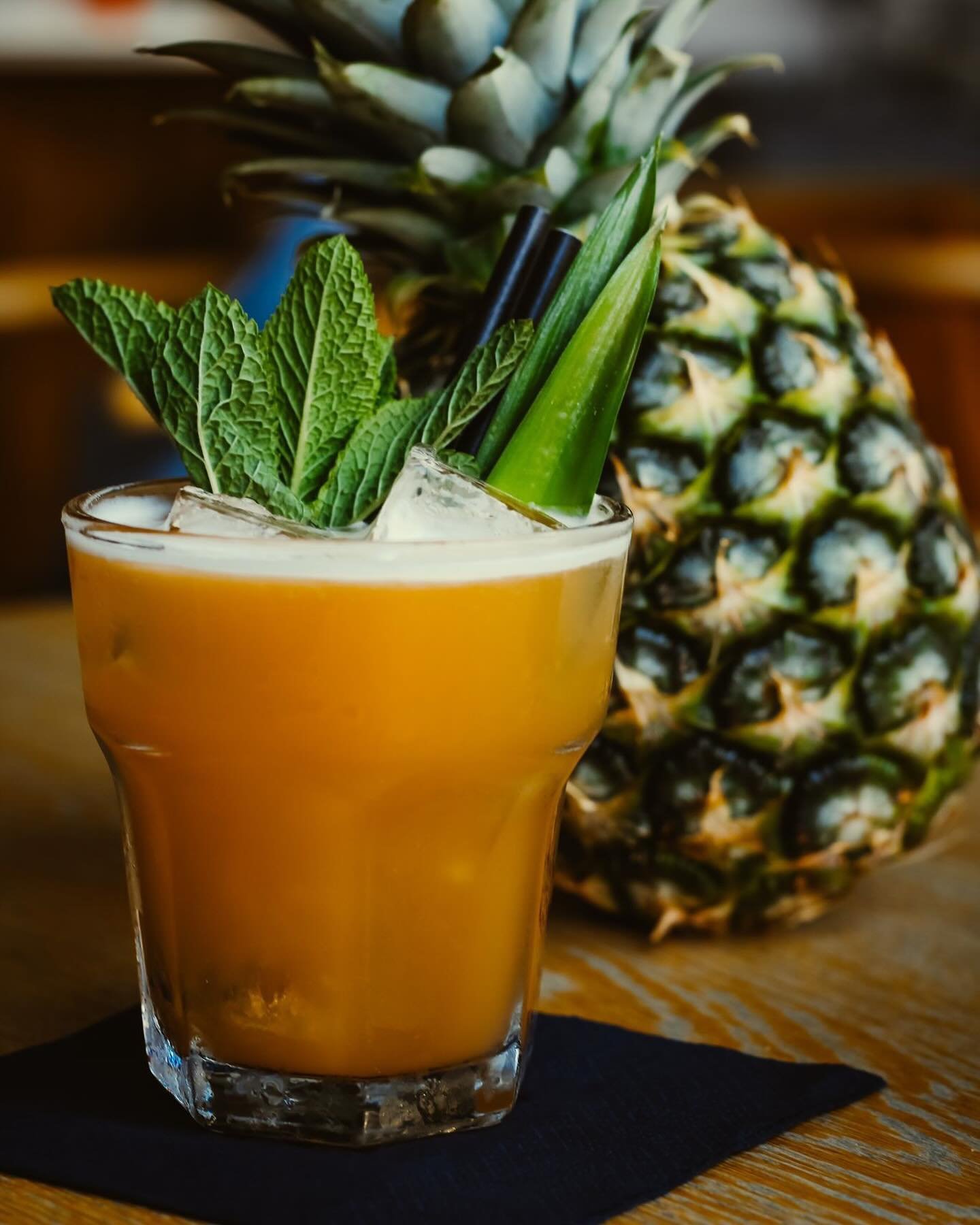 The Cardinal - Bourbon, campari, pineapple juice, passion fruit, lemon and mint. 🍍