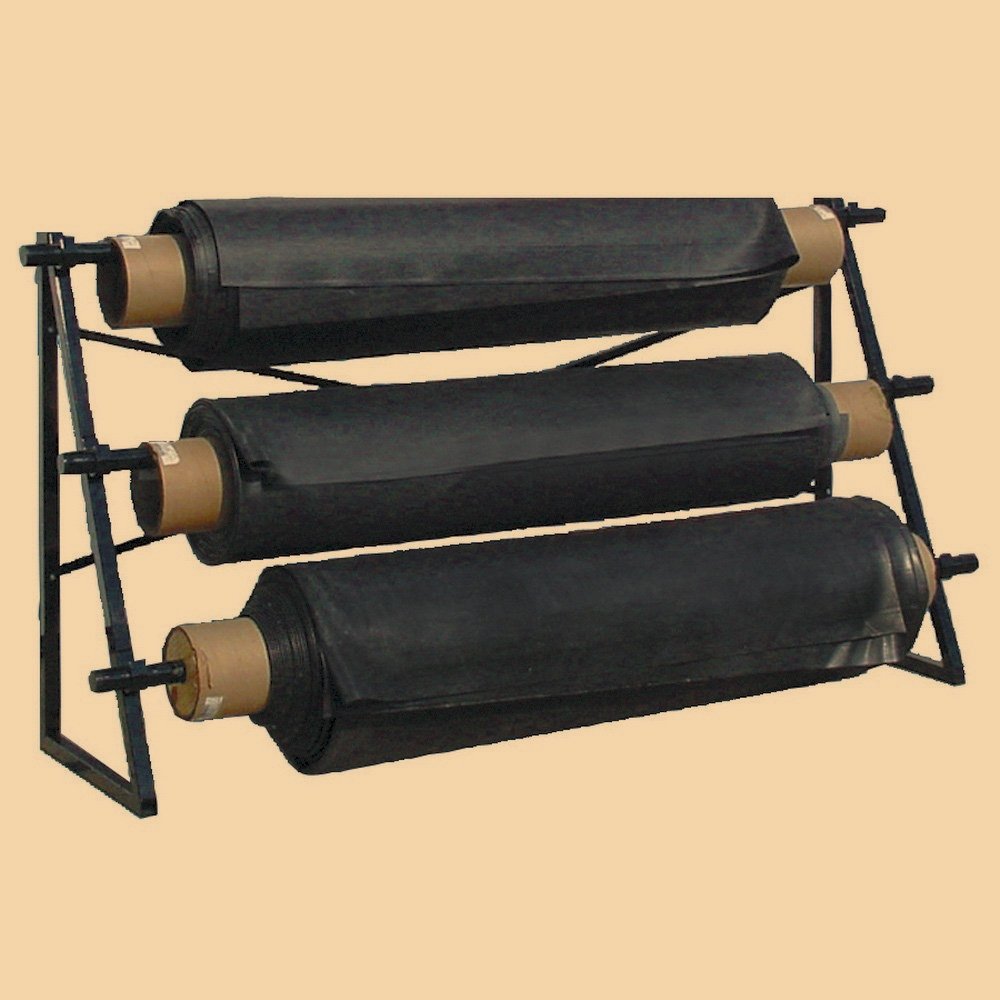 Three large black rolls of outdoor carpet or turf on a metal rack.
