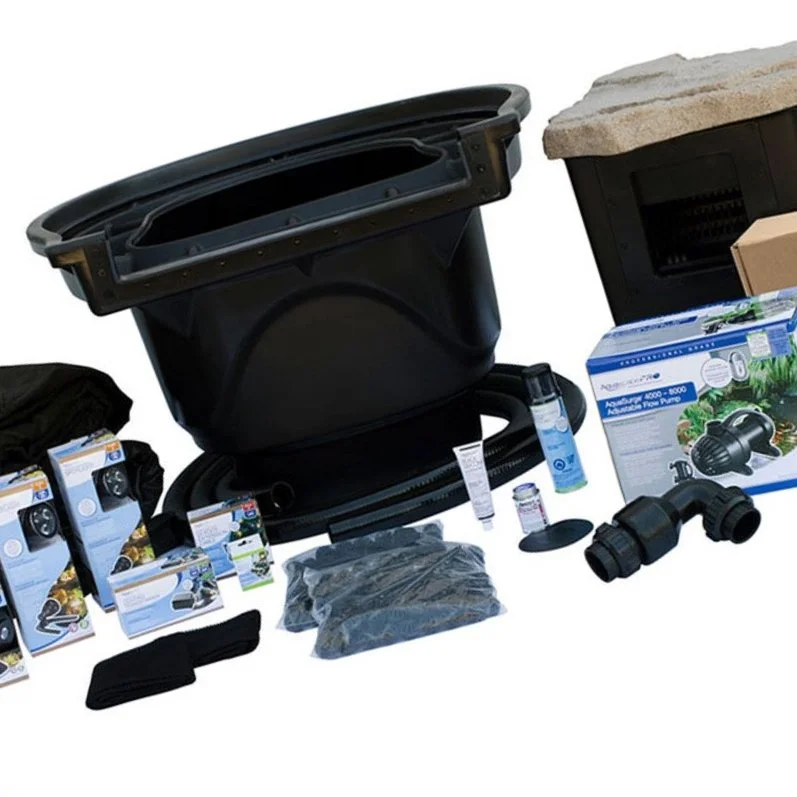 Disassembled pond filtration system components, including a large black container, tubing, filters, and pump, arranged on a white background.