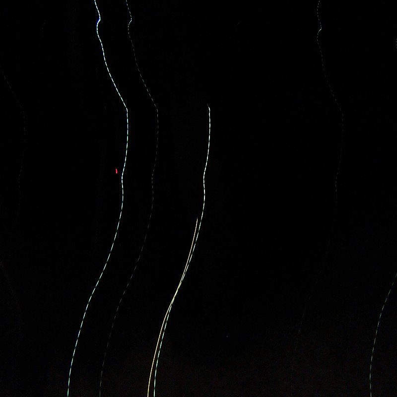 Long exposure photograph of light trails against a dark background