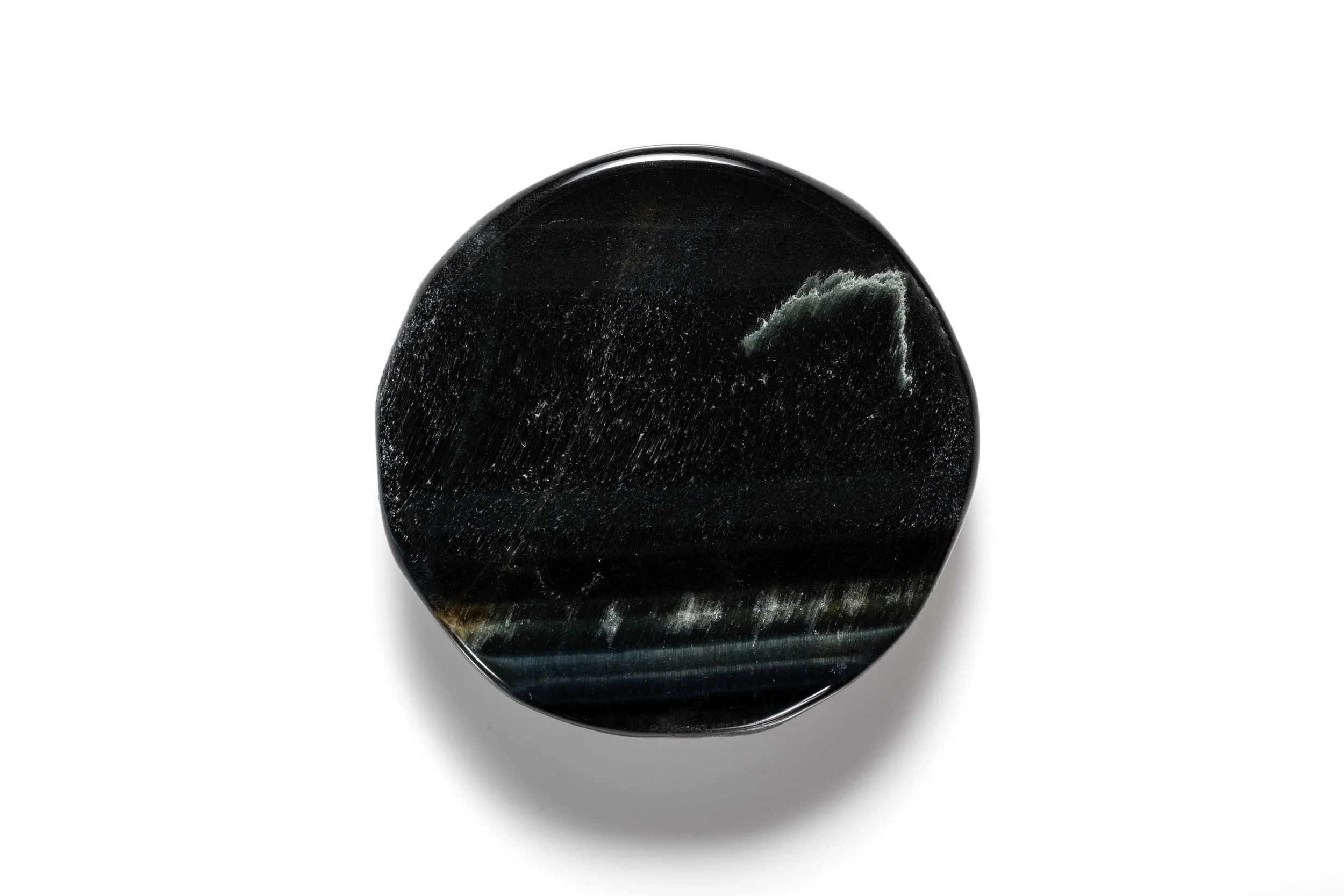Rear view of the red beetle cabochon, showing its oval black stone base.