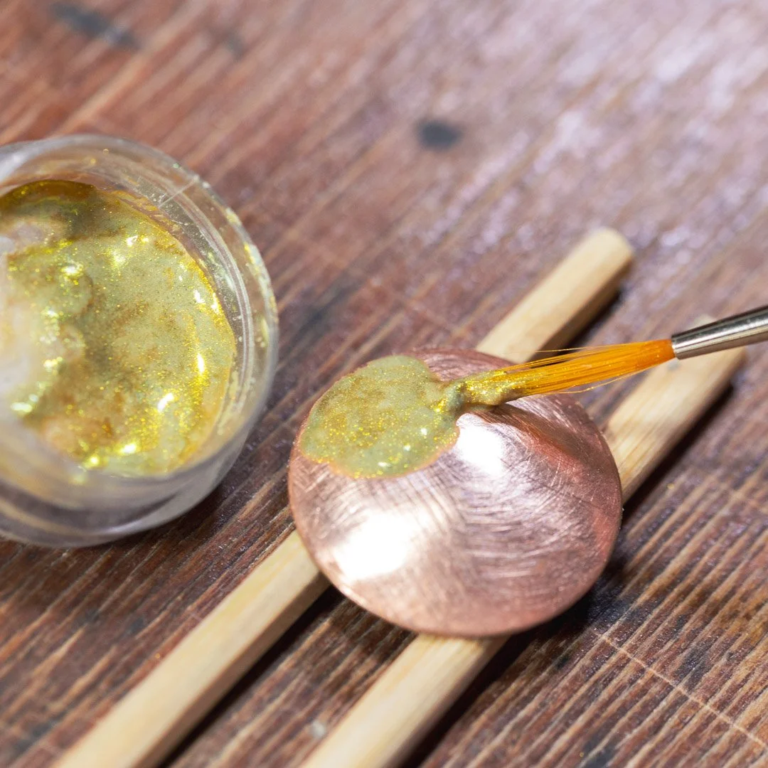 Wet packing a thin layer of enamel.