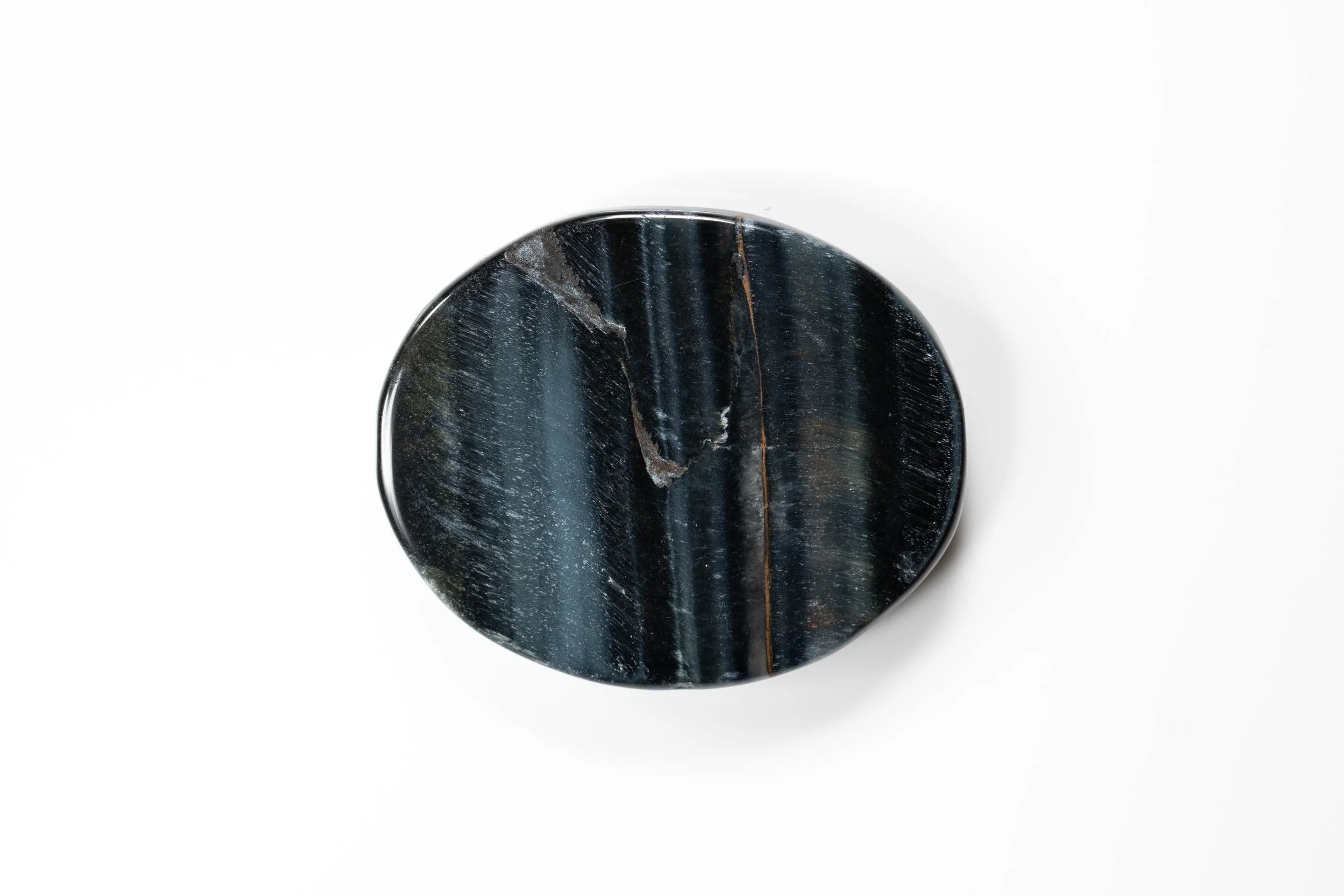 Rear view of the luna moth cabochon, showing natural streaks in the round black stone base.