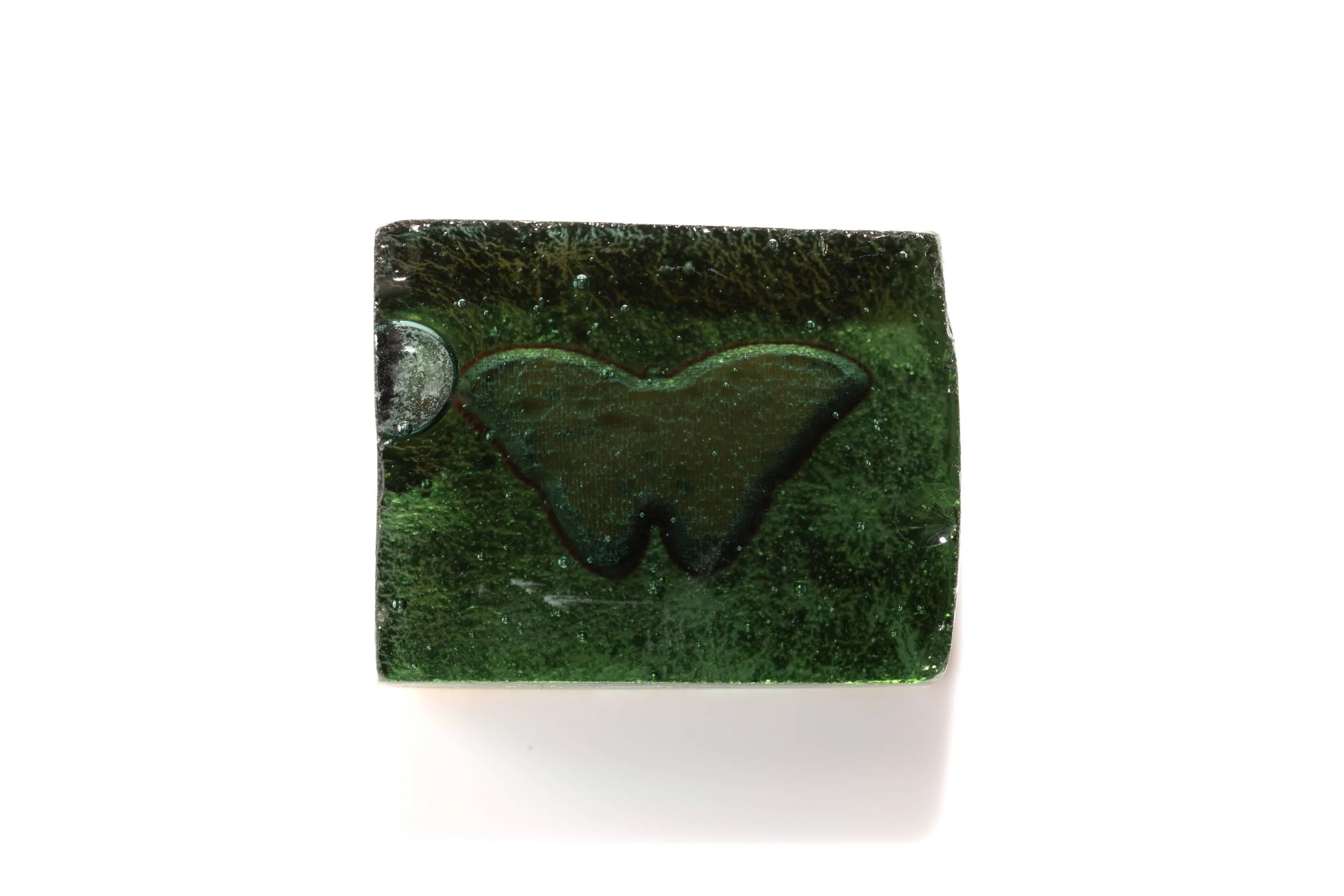 Rear view of the blue butterfly cabochon, showing the dark green square base and butterfly-shaped outline.