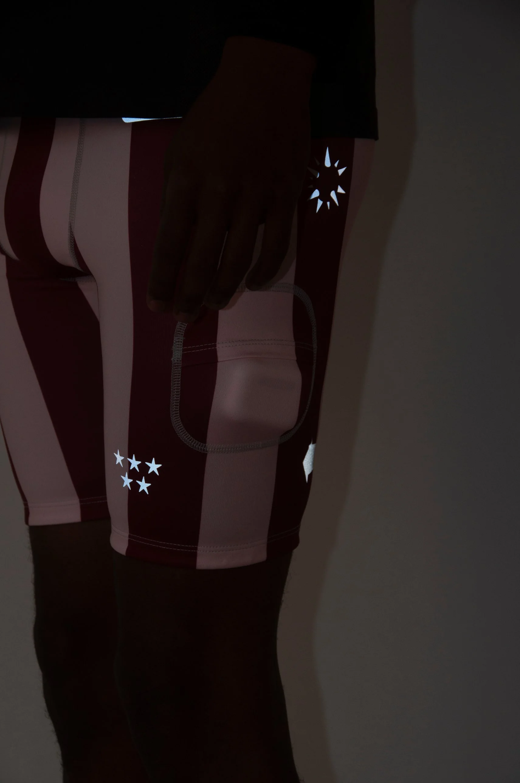 Energy Shorts® Crush under camera flash in a dark room: the reflective graphics light up