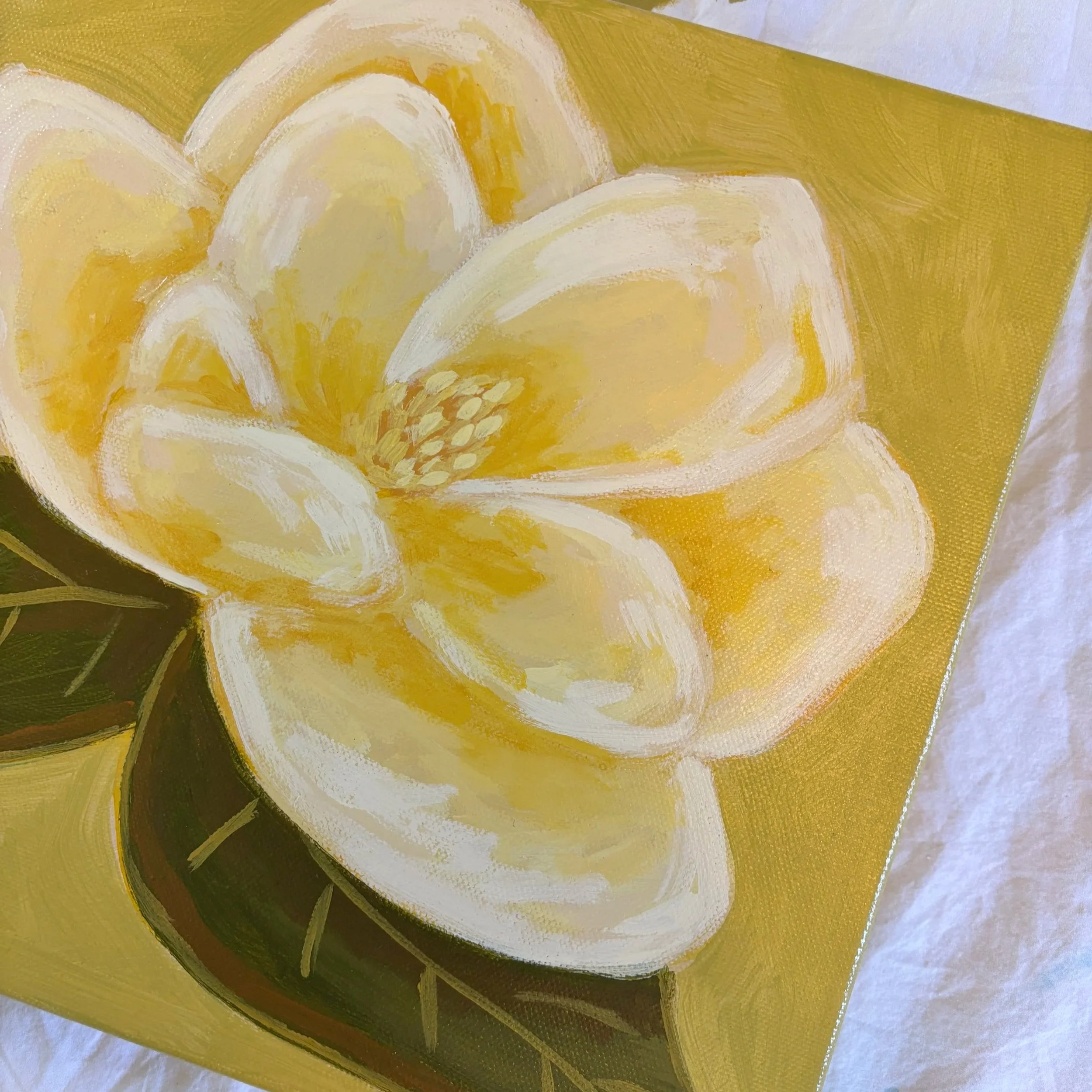 Original acrylic magnolia painting with a warm cream-colored bloom and soft green leaves set against a fresh lime green background.