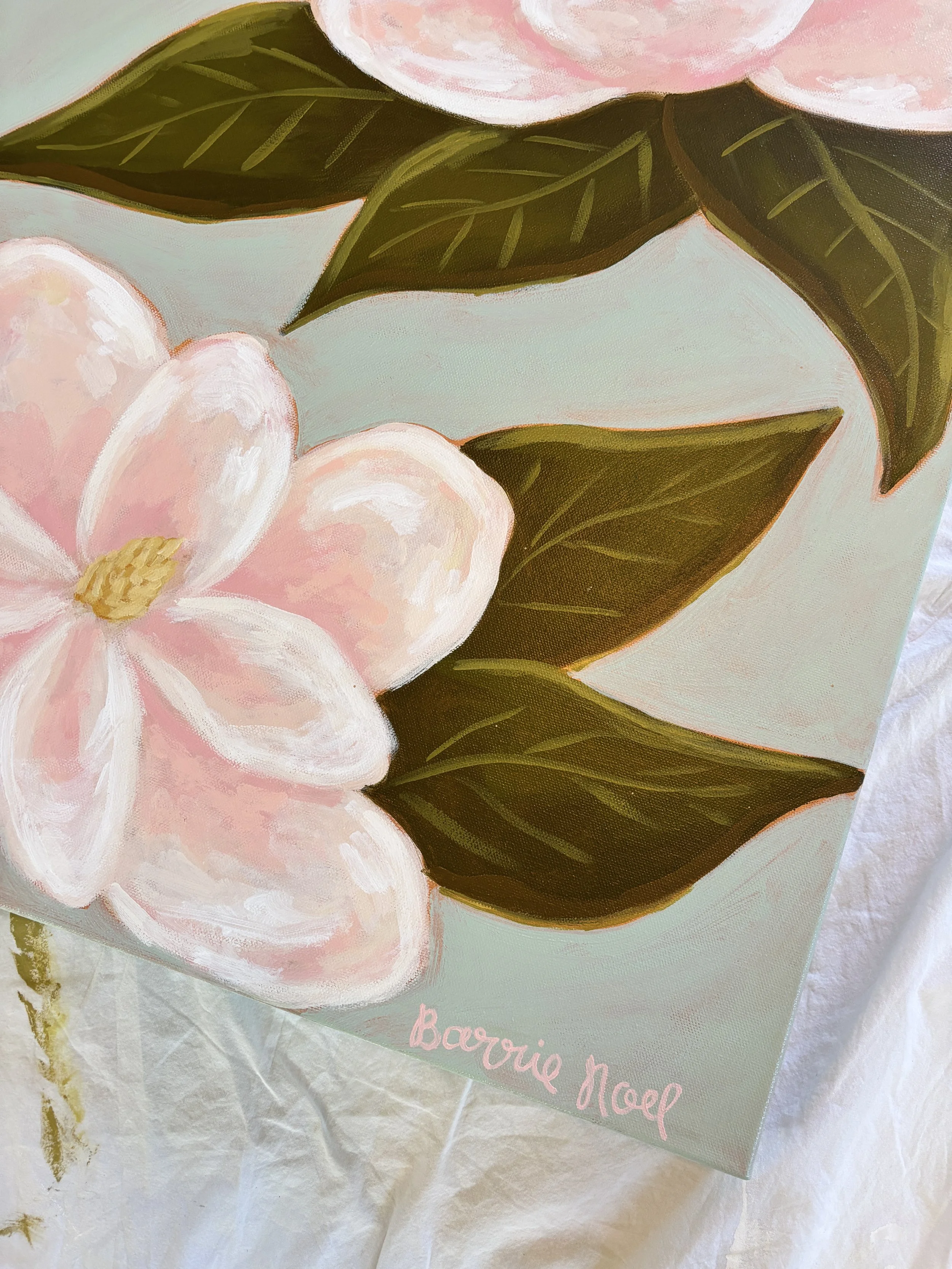 Original acrylic magnolia painting with pale pink blooms and soft green leaves on a light blue background.