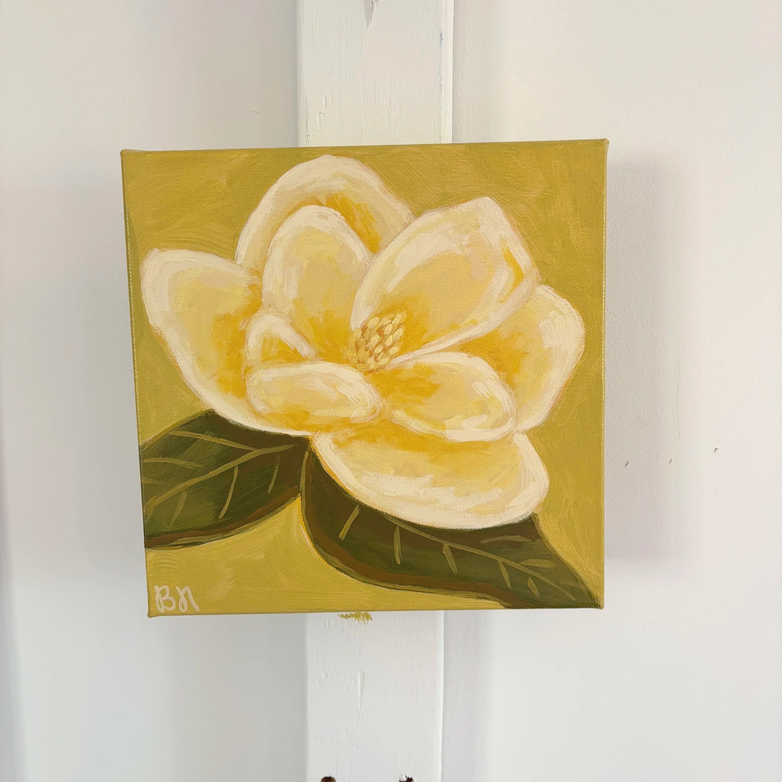 Original acrylic magnolia painting with a warm cream-colored bloom and soft green leaves set against a fresh lime green background.