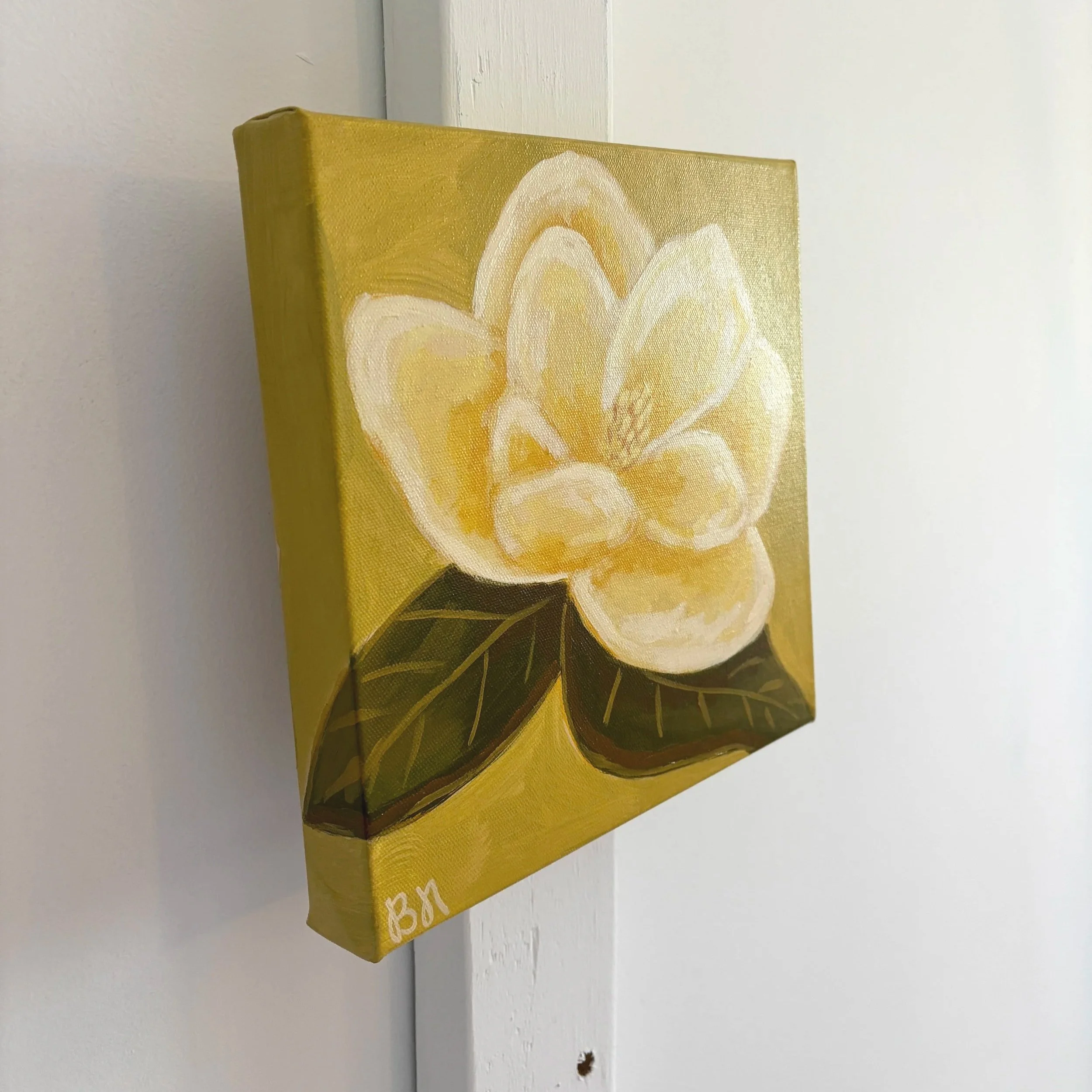 Original acrylic magnolia painting with a warm cream-colored bloom and soft green leaves set against a fresh lime green background.