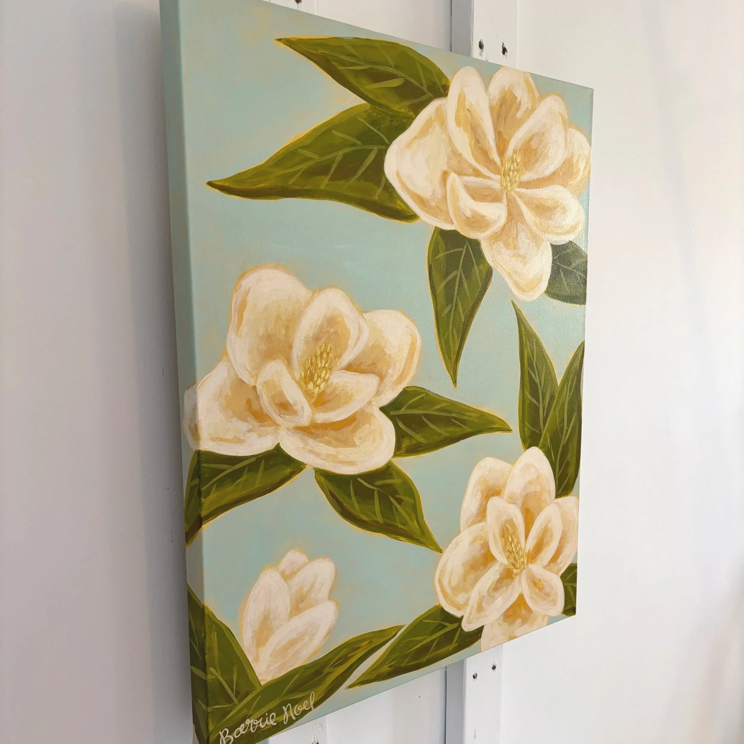 Original acrylic magnolia painting with cream blooms and soft green leaves on a light blue background.