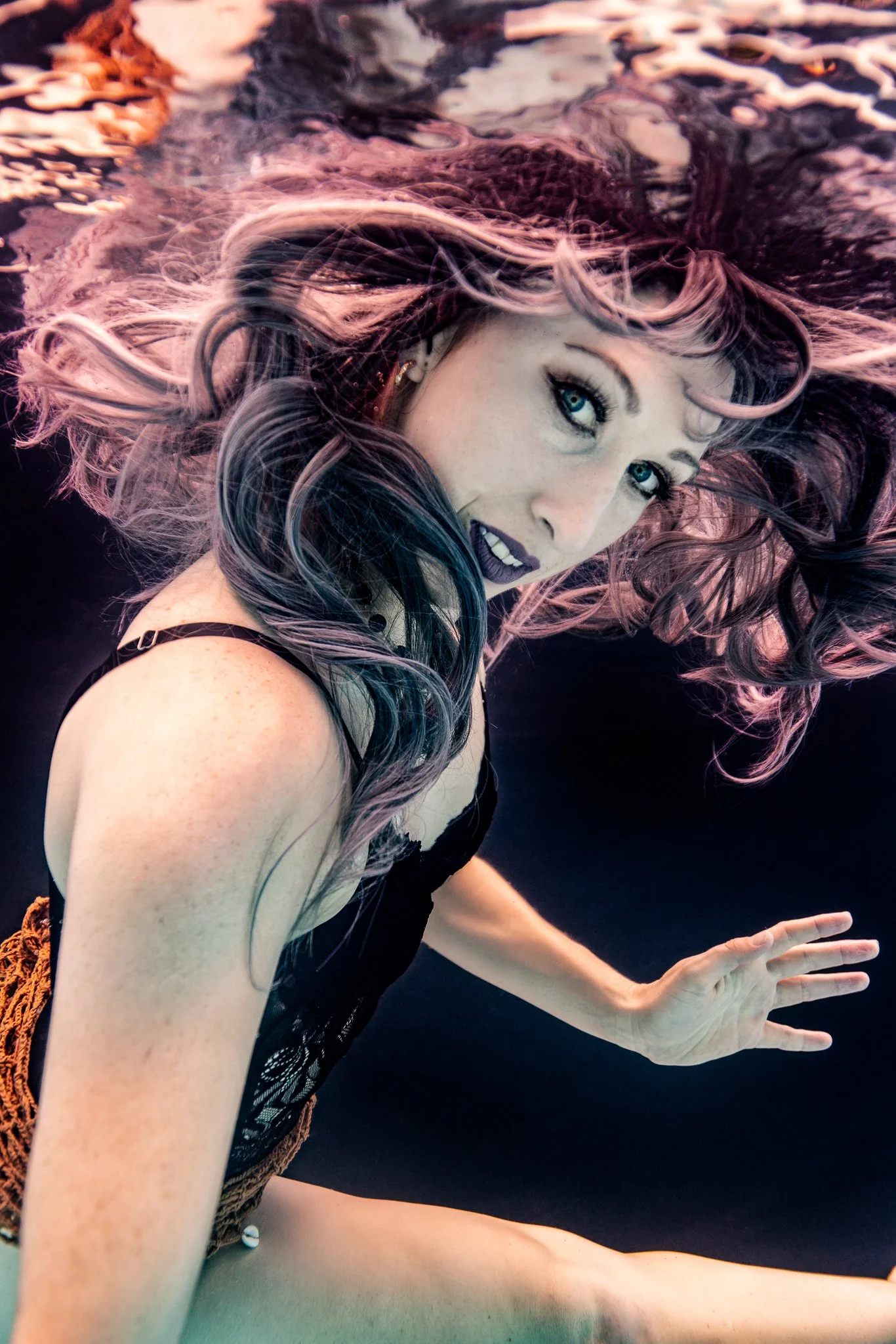 underwater model with flowing hair smile