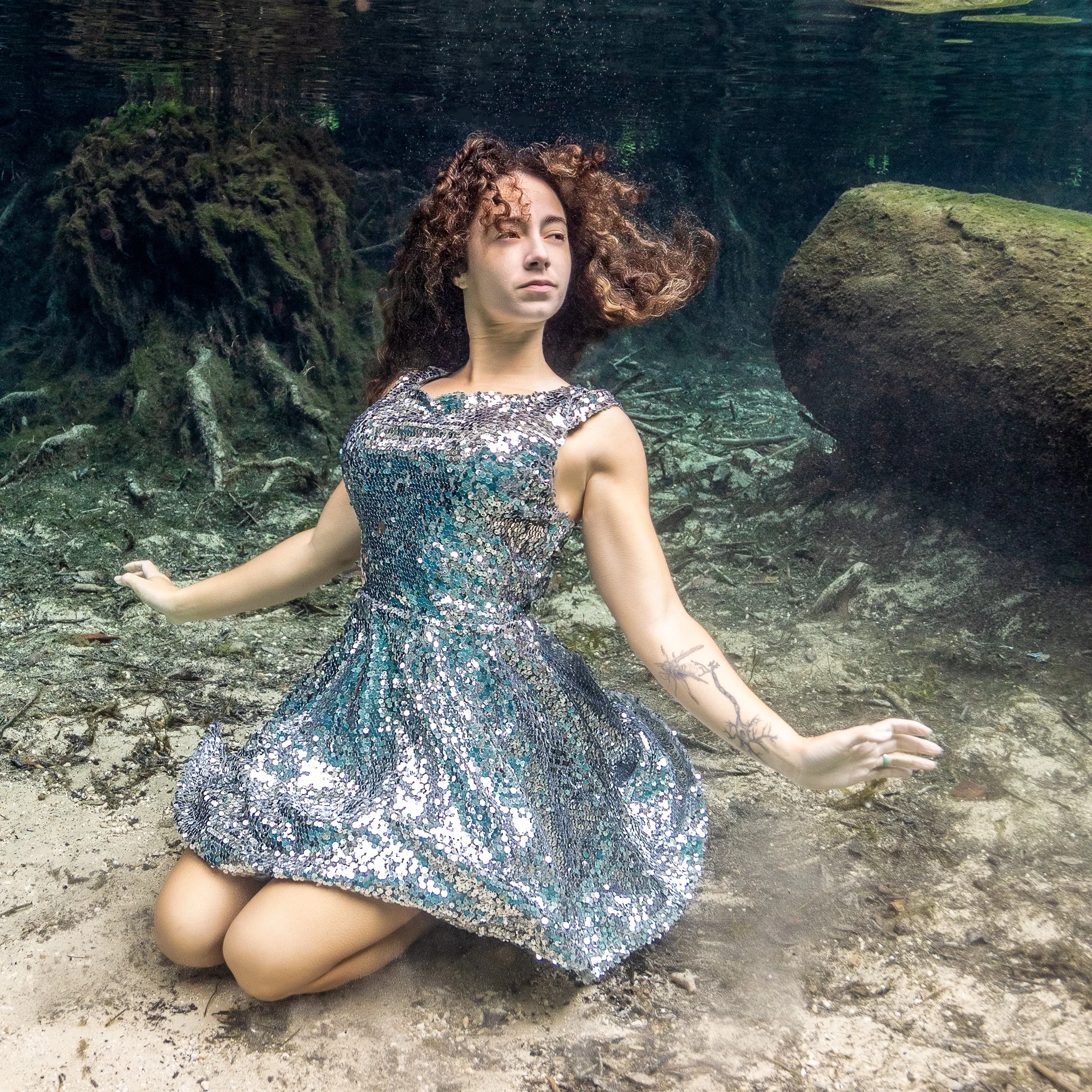 Veronica in a silver sequined dress drifts to the bottom of Ginnie Springs near Gainesville FL