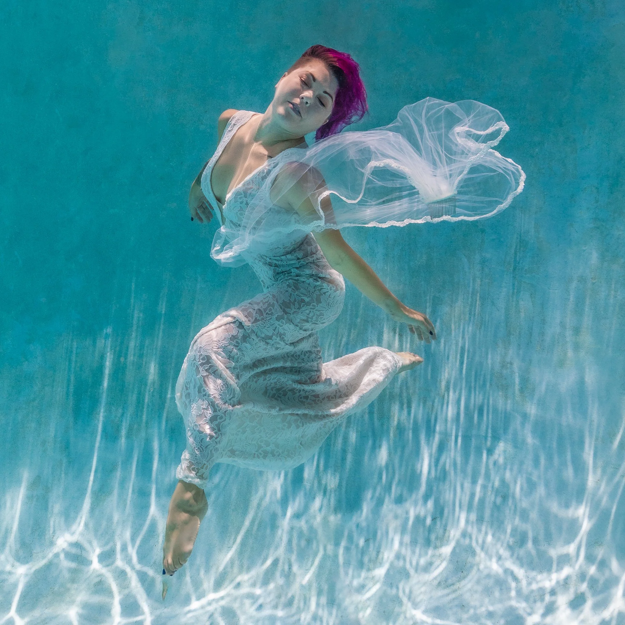 Michelina floats in her wedding dress in a heated pool in Orlando, FL