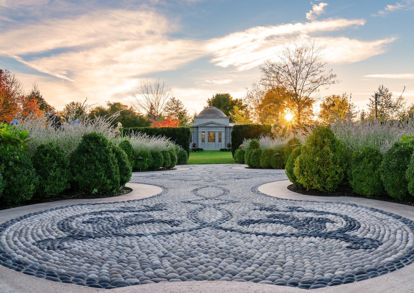 As the sun begins to set on this breathtaking project in Greater Boston, soft lighting illuminates every detail; the craftsmanship by our masons, the hedges trimmed by our maintenance crew and the lighter hued perennials placed by our expert design p