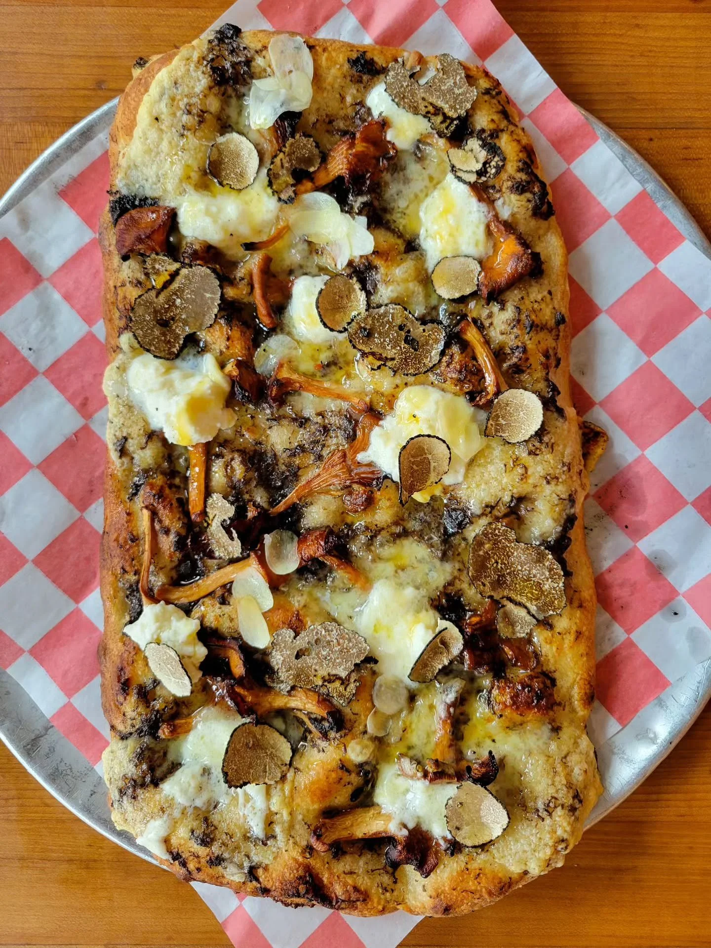 Truffle season is here, and we've got an extra special pizza this week for the occasion!
Over the years, we've created different truffle pies, and this one might just be our favorite. We love how the wild chanterelles and freshly grated truffles com